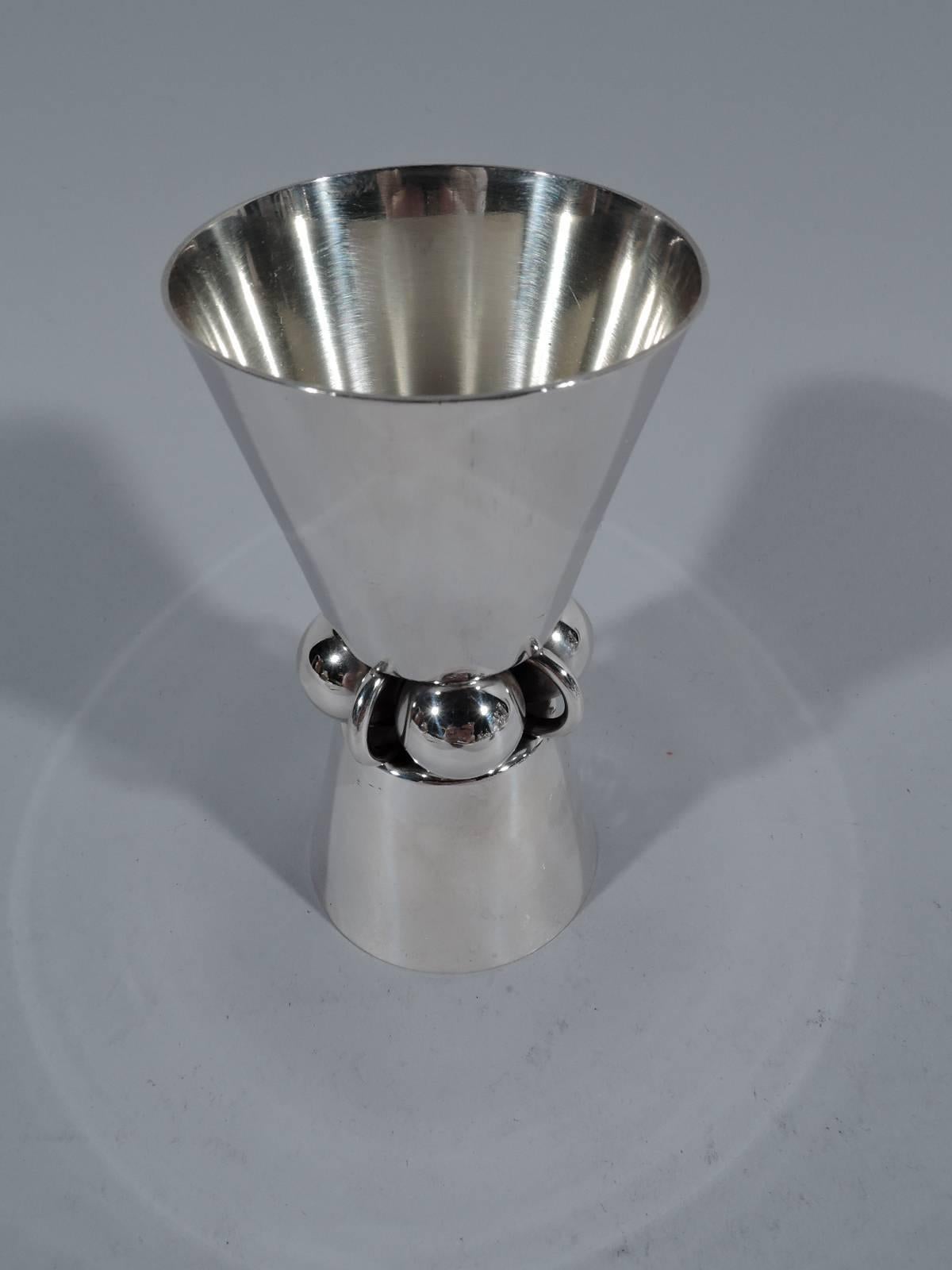 Mid-Century Modern sterling silver jigger. Made by Alphonse La Paglia for International in Meriden, Conn. Big and small truncated cones mounted back-to-back to Jensen-inspired knop with alternating beads and rings. A useful piece rich in period