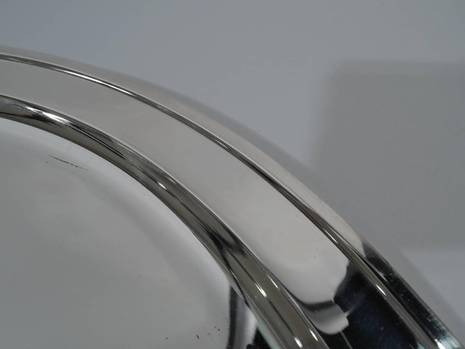 Modern sterling silver serving tray. Made by Tiffany & Co. in New York. Circular well and 1/8-inch applied rim. Hallmark includes postwar pattern no. 23749. Heavy weight: 32 troy ounces.