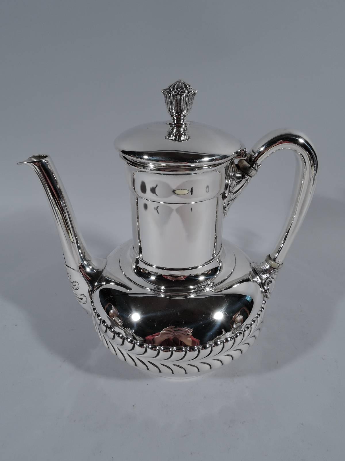 Sterling silver coffee set on tray. Made by Tiffany & Co. in New York. This set comprises coffeepot, creamer, sugar, and tray.

Coffeepot: Bellied bowl and drum-form neck with raised hinged cover and high-looping scroll handle. Creamer: Bellied