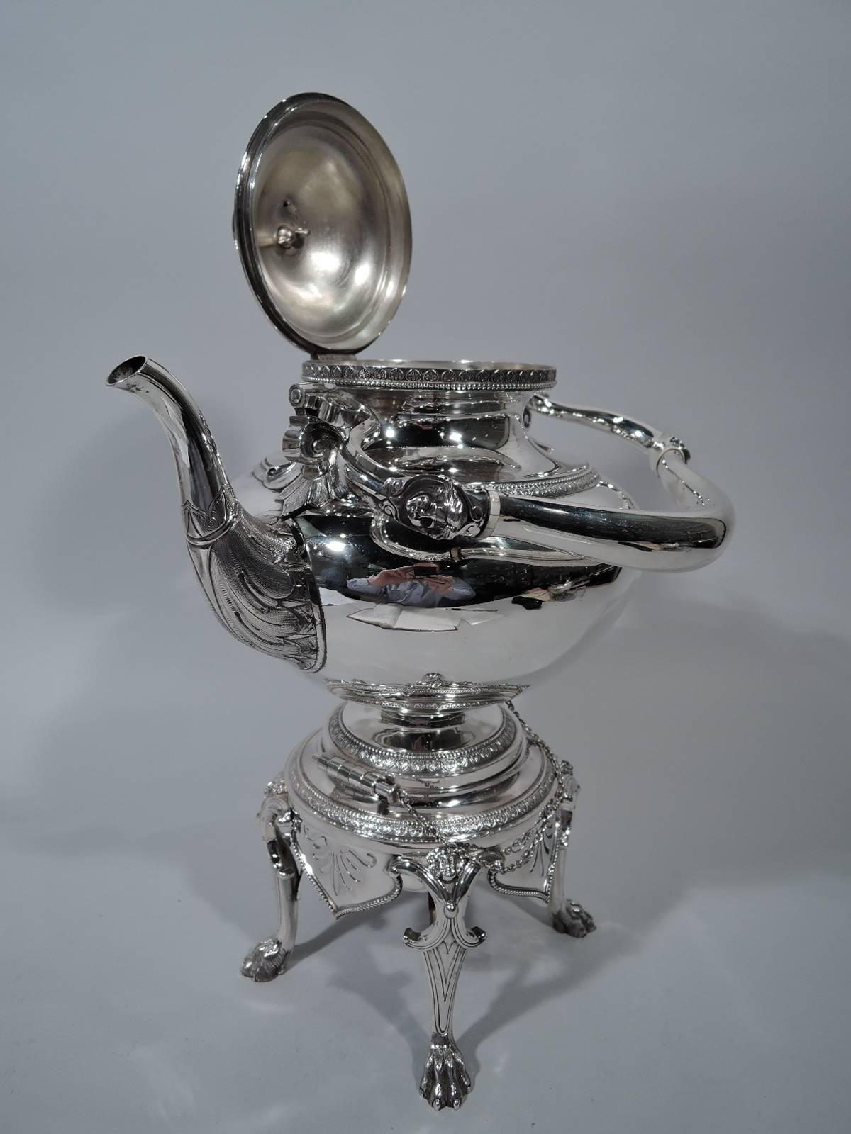 A fine sterling silver hot water kettle on stand. Made by Tiffany & Co. in New York. Kettle bellied with raised foot. Swing handle has volute terminals. Spout has beautifully chased leaves. Cover side-hinged and domed with cast finial in form of