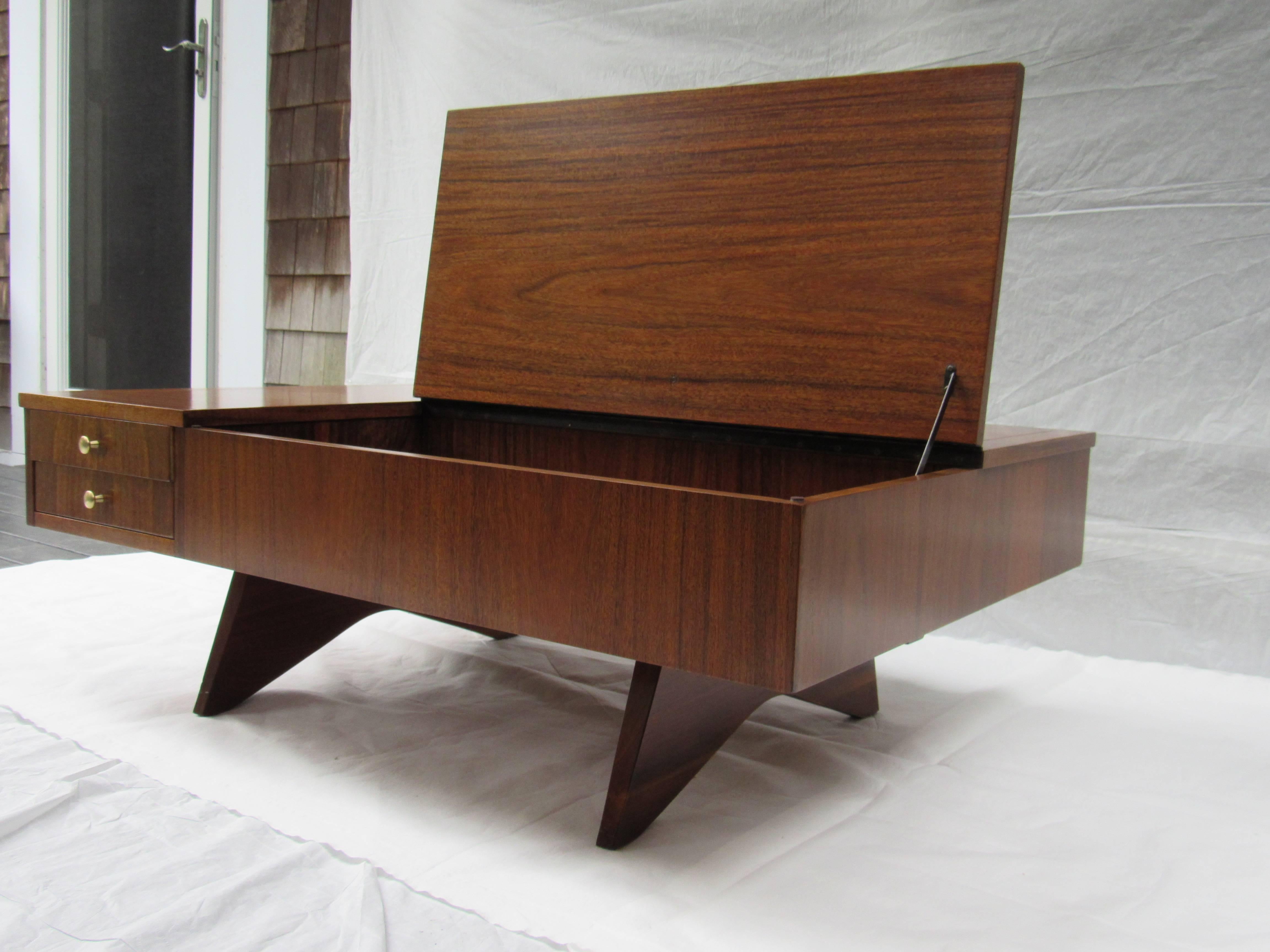 George Nakashima flip-top coffee table model 272 manufactured by Widdicomb in 1961 from his Origins line .
The underside of the drawer is stenciled Sundra 2/ 61 272.
The coffee table is in excellent condition.