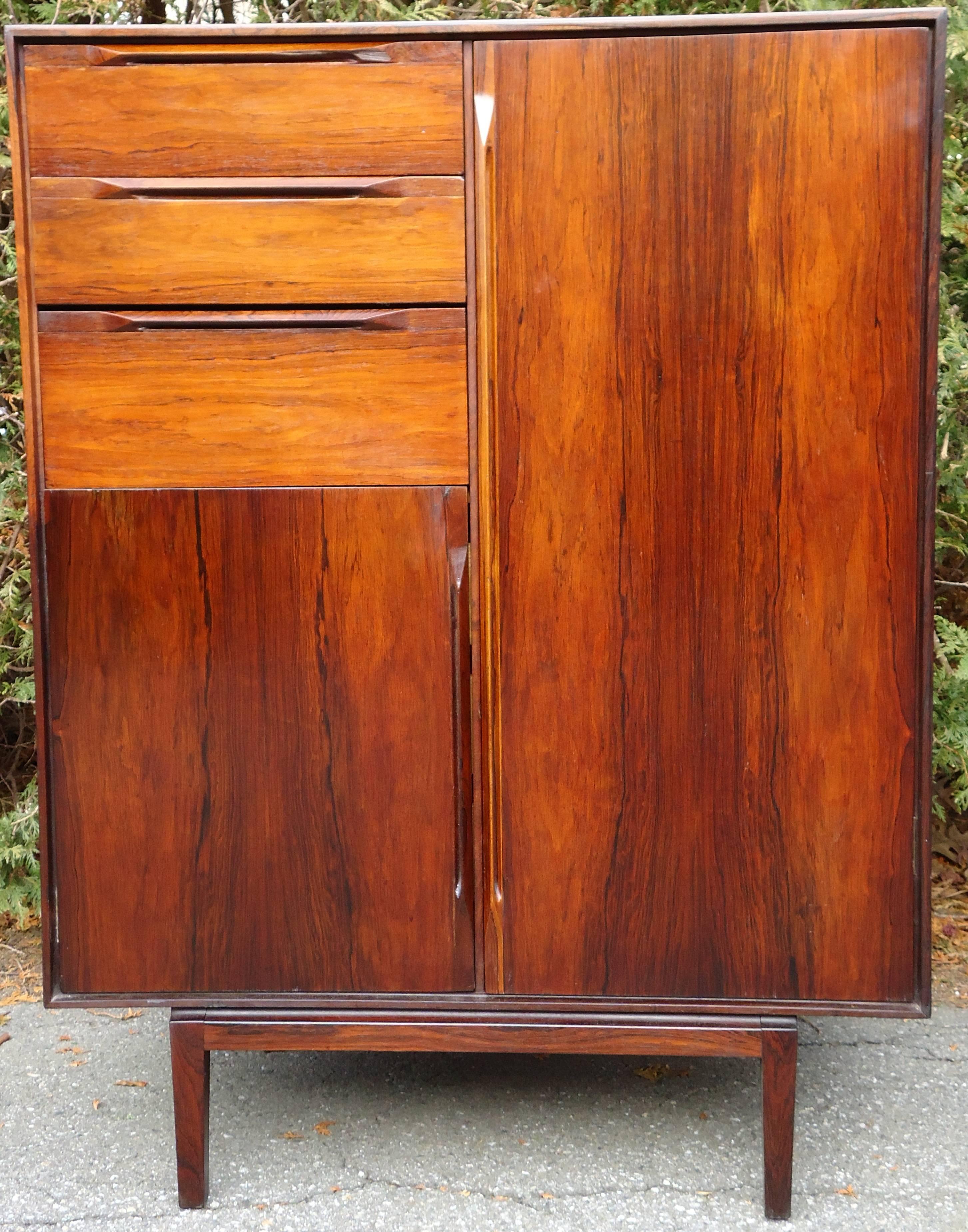 A rosewood wardrobe with six drawers and a closet to hang clothes in.  
This is an rare early cabinet from one of Denmark's premier cabinet makers France and Son attributed to Finn Juhl. 
On the interior of the back panel behind the lower drawers is