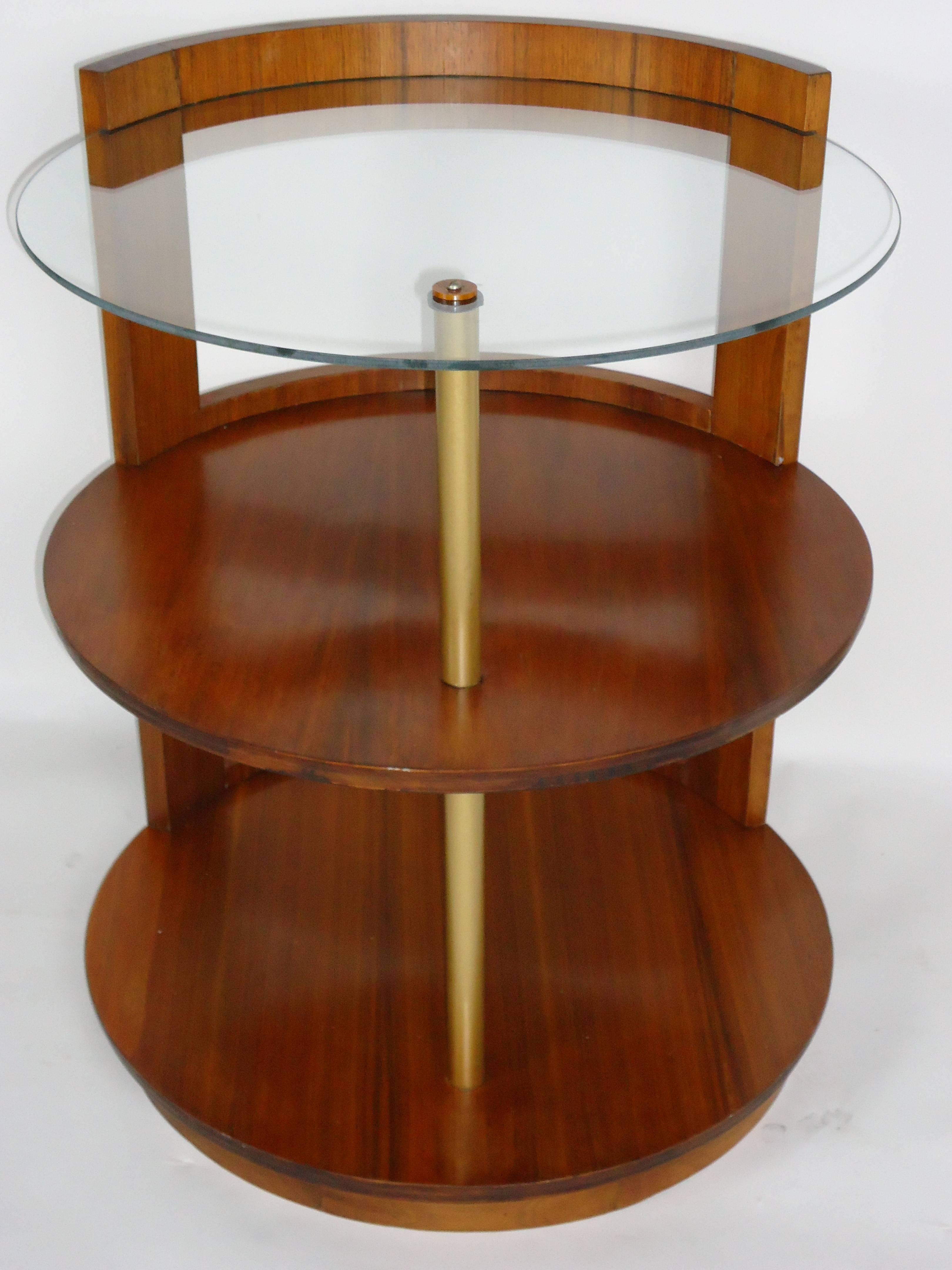 A rare Gilbert Rohde three-tier walnut side table or nightstand designed for Herman Miller in the late 1930s.
An unusual design because of its cut-out back.
The table has a replaced glass top shelf and is in excellent condition.
 