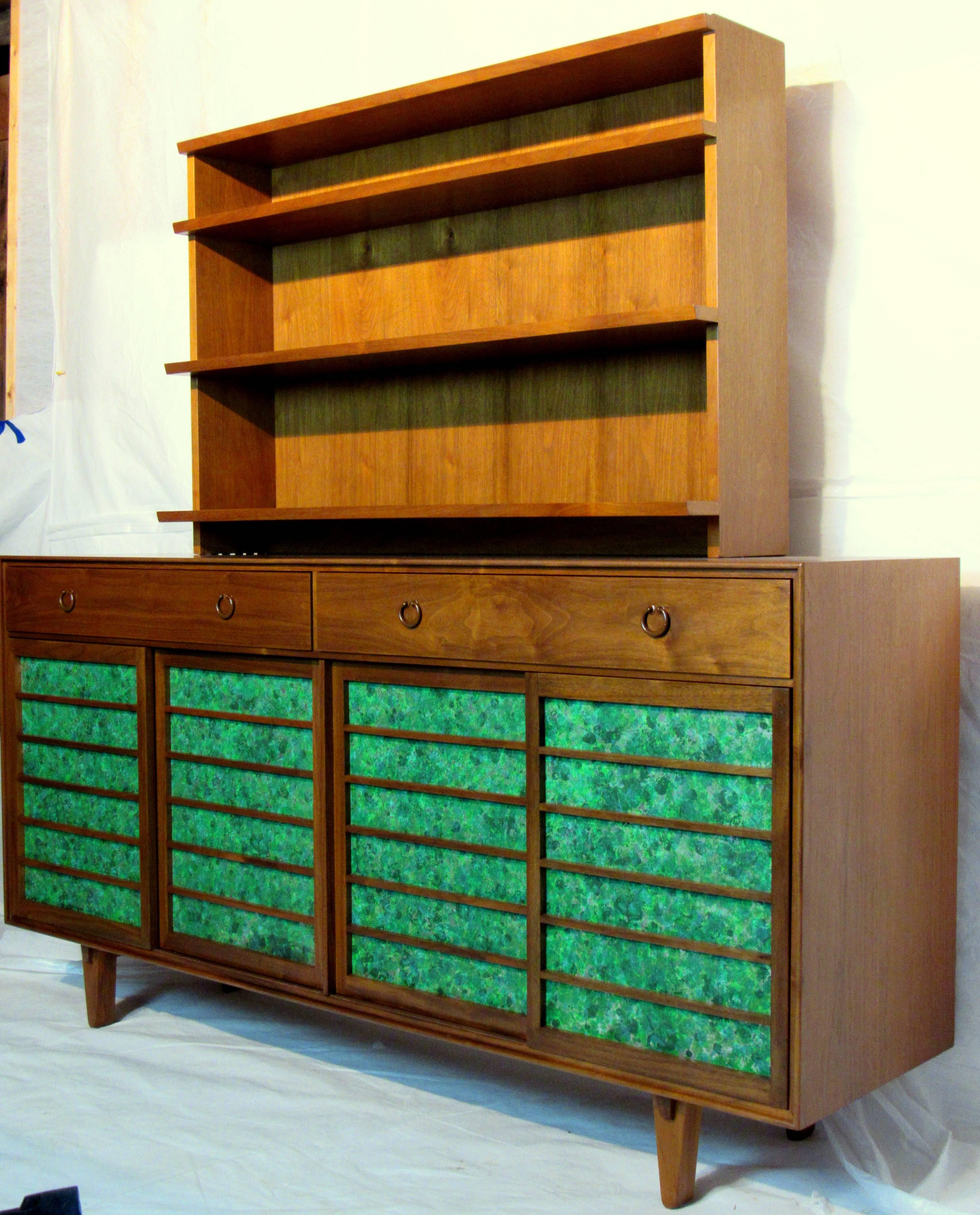An Edward Wormley walnut and Japanese fir sideboard , model 671A for Dunbar, circa 1953.
A rare exquisite Japanese inspired walnut cabinet with two drawers with cast bronze pulls and featuring four sliding walnut doors with inset panels of oil drop