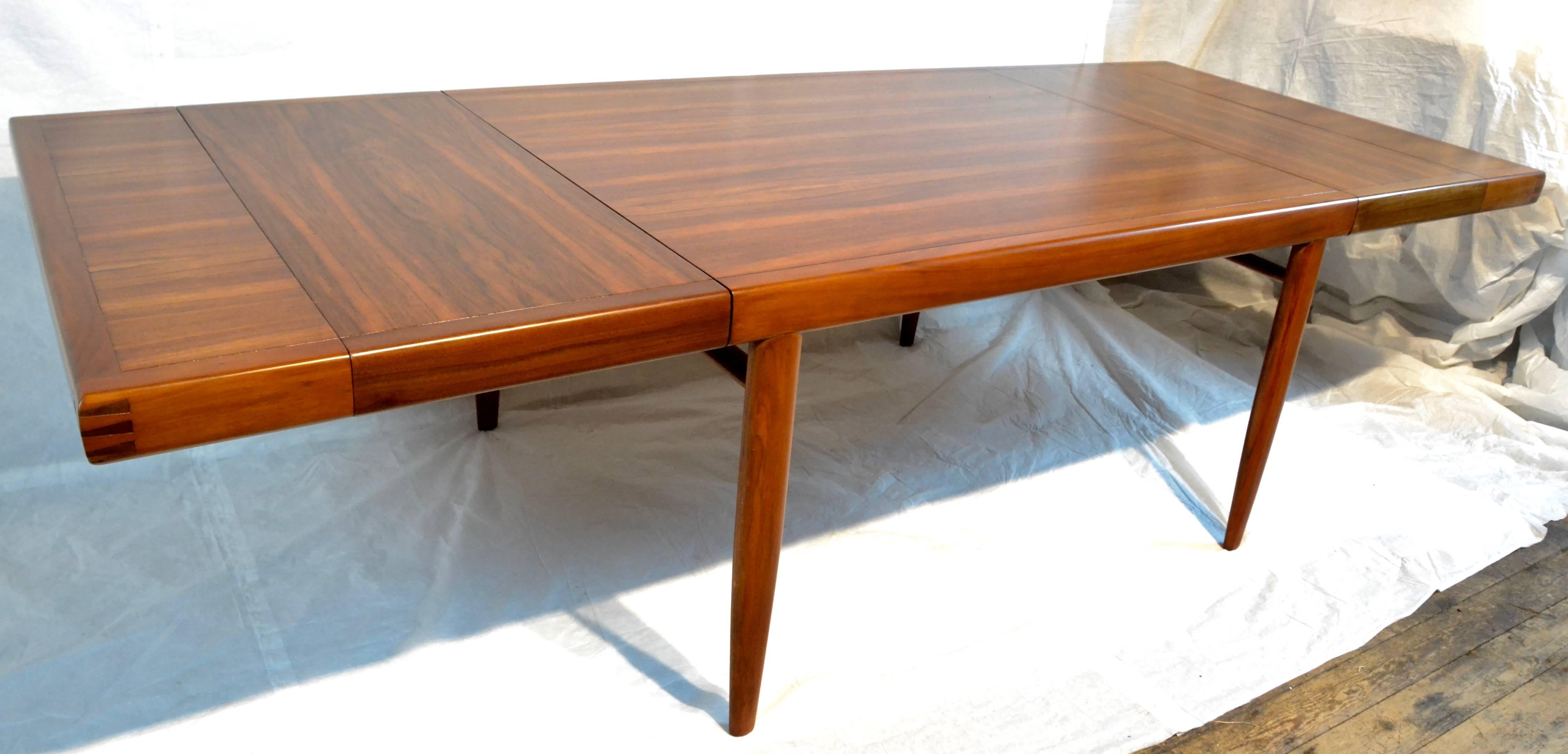 A refractory dining table designed by George Nakashima for Widdicomb. 
The top is East India Laurel framed in American Walnut. 
Nakashima's Origins line of Furniture was available in Walnut, Carpathian Elm, Laurel and Rosewood.  
The table has a