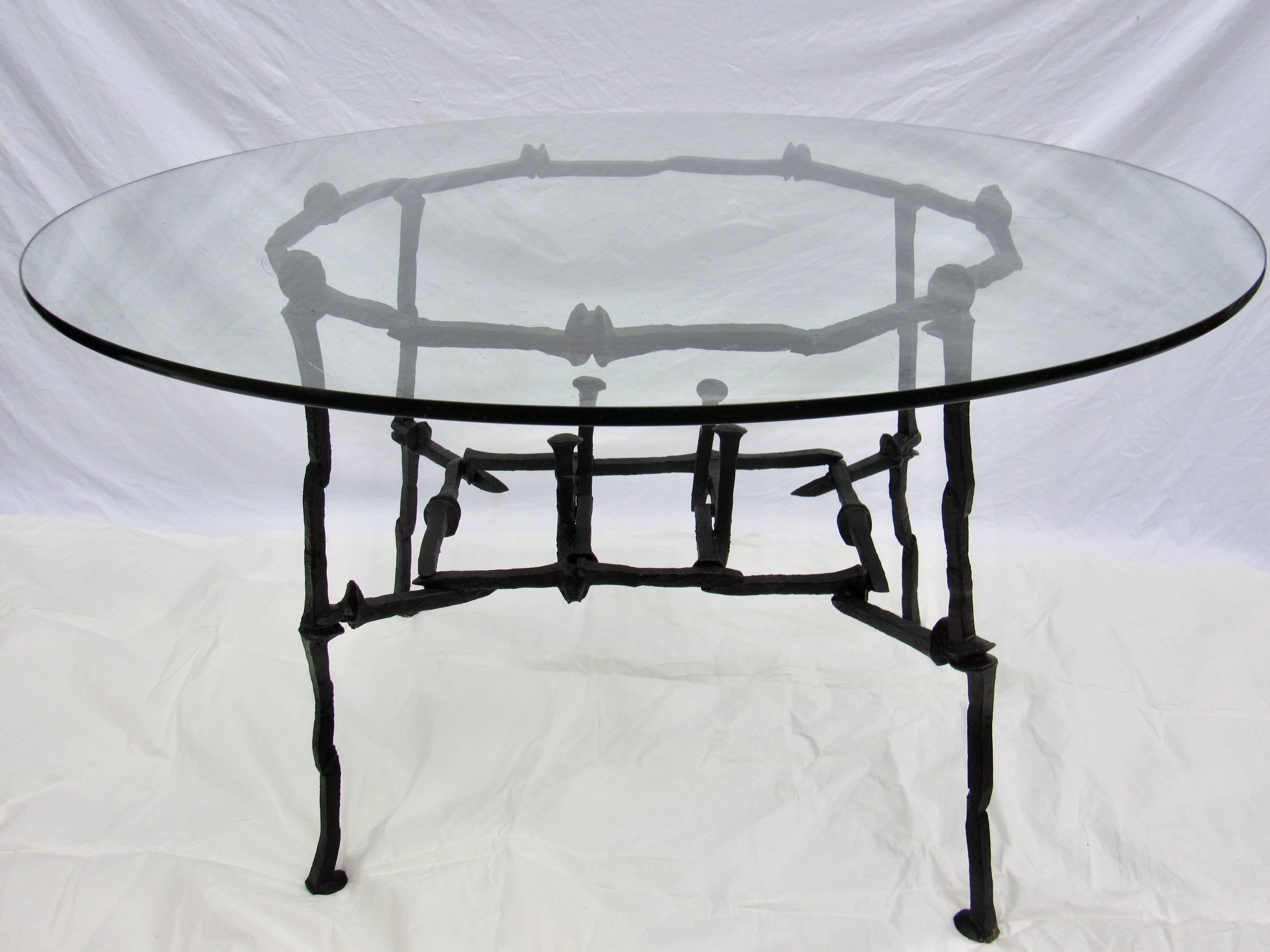 Studio created welded RR spike breakfast or center table shown with a 42 inch diameter glass 3/8 inch thick. The legs of the frame are within 36 inch in diameter and the upper ring of the table frame is 32 inch in diameter.
The table is in excellent