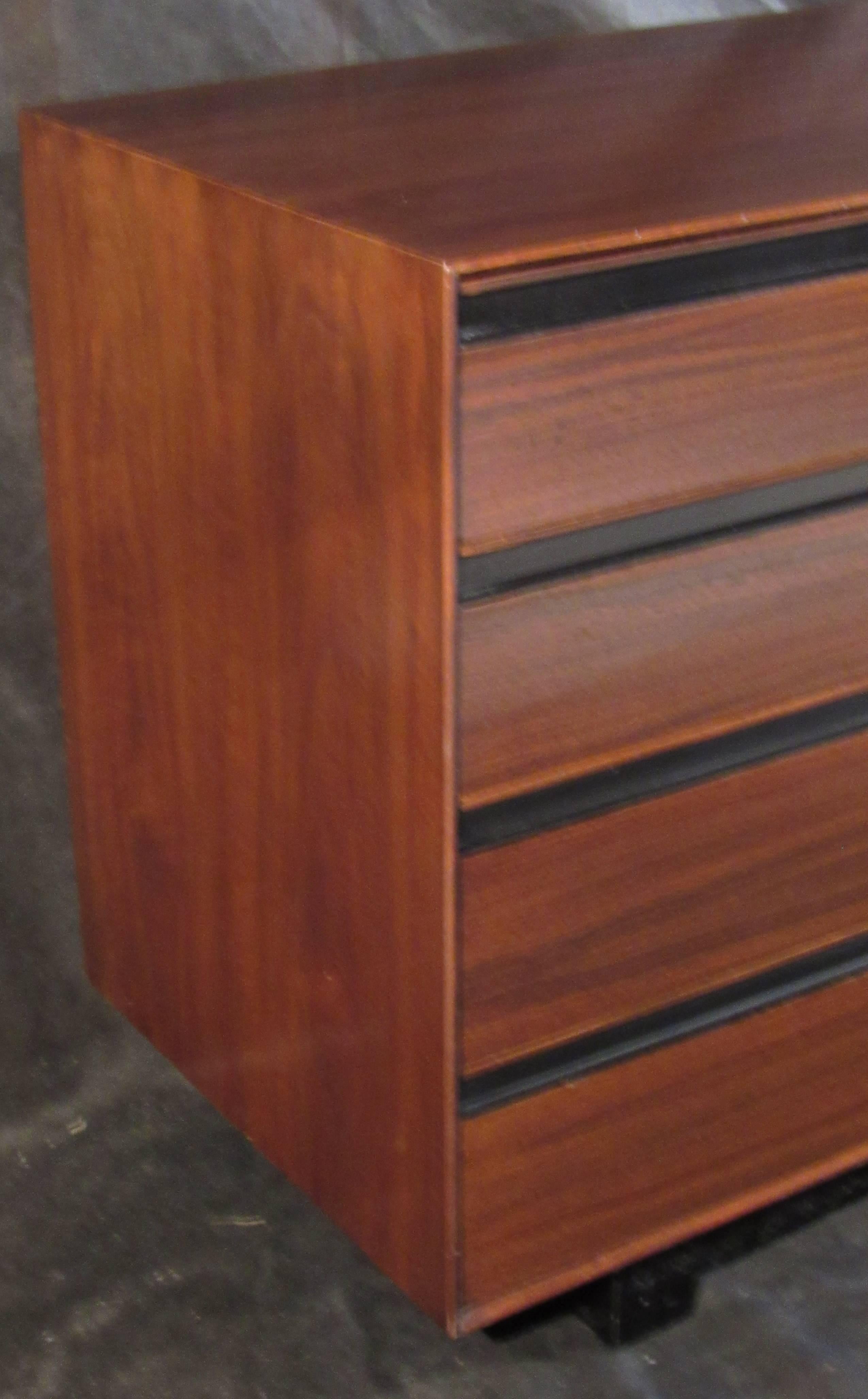 A black walnut eight-drawer dresser designed by John Kapel and manufactured by Glenn of California that features exceptional grain, sculpted pulls with black Lucite trim details that combine in a sophisticated design. Professionally restored in