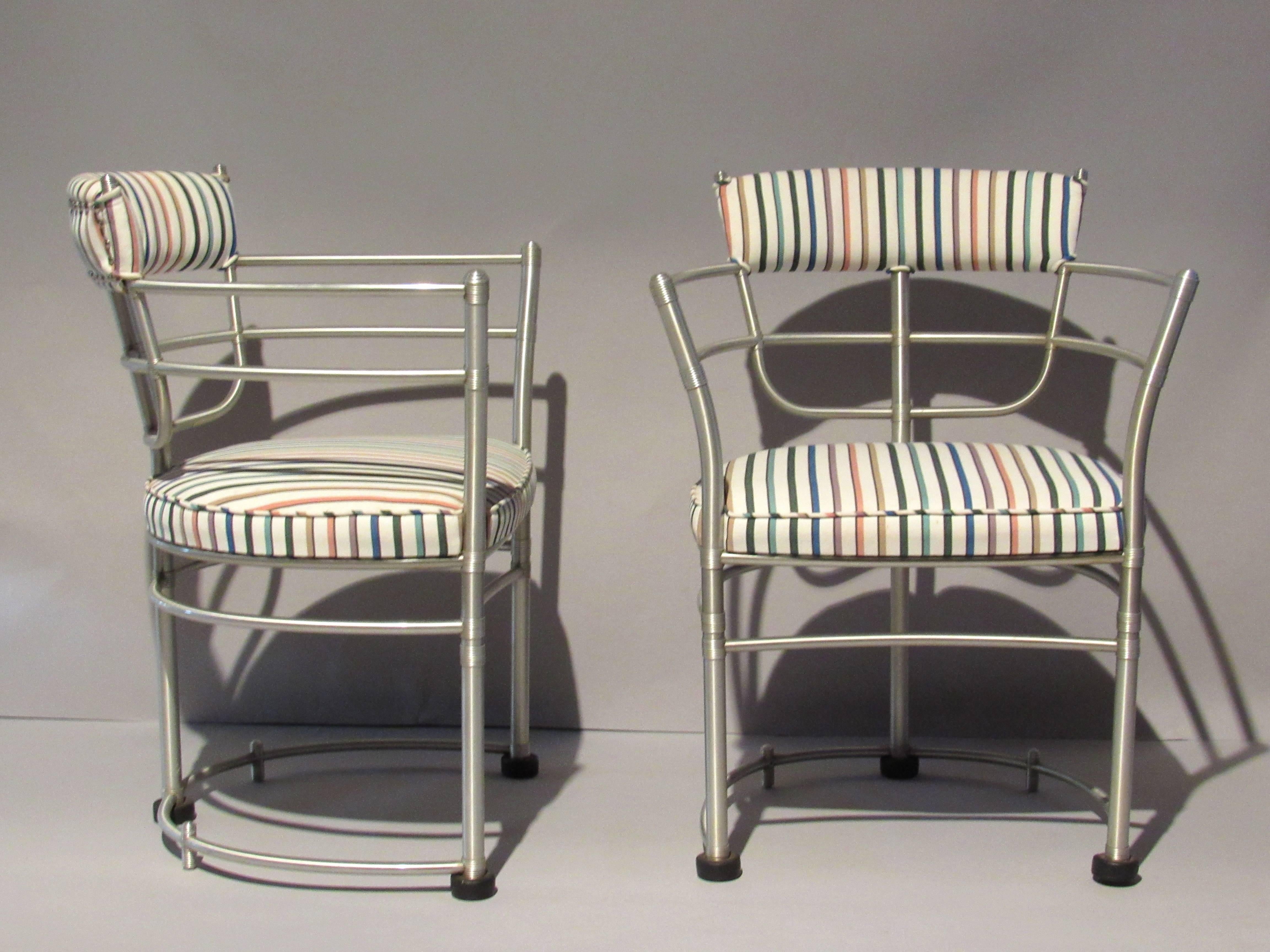 Two early aluminum armchairs manufactured in Rome, New York by the Warren McArthur Corporation during the first two years of production from that factory.
The chairs were re-upholstered probably during the early 1960s in this colorfully striped