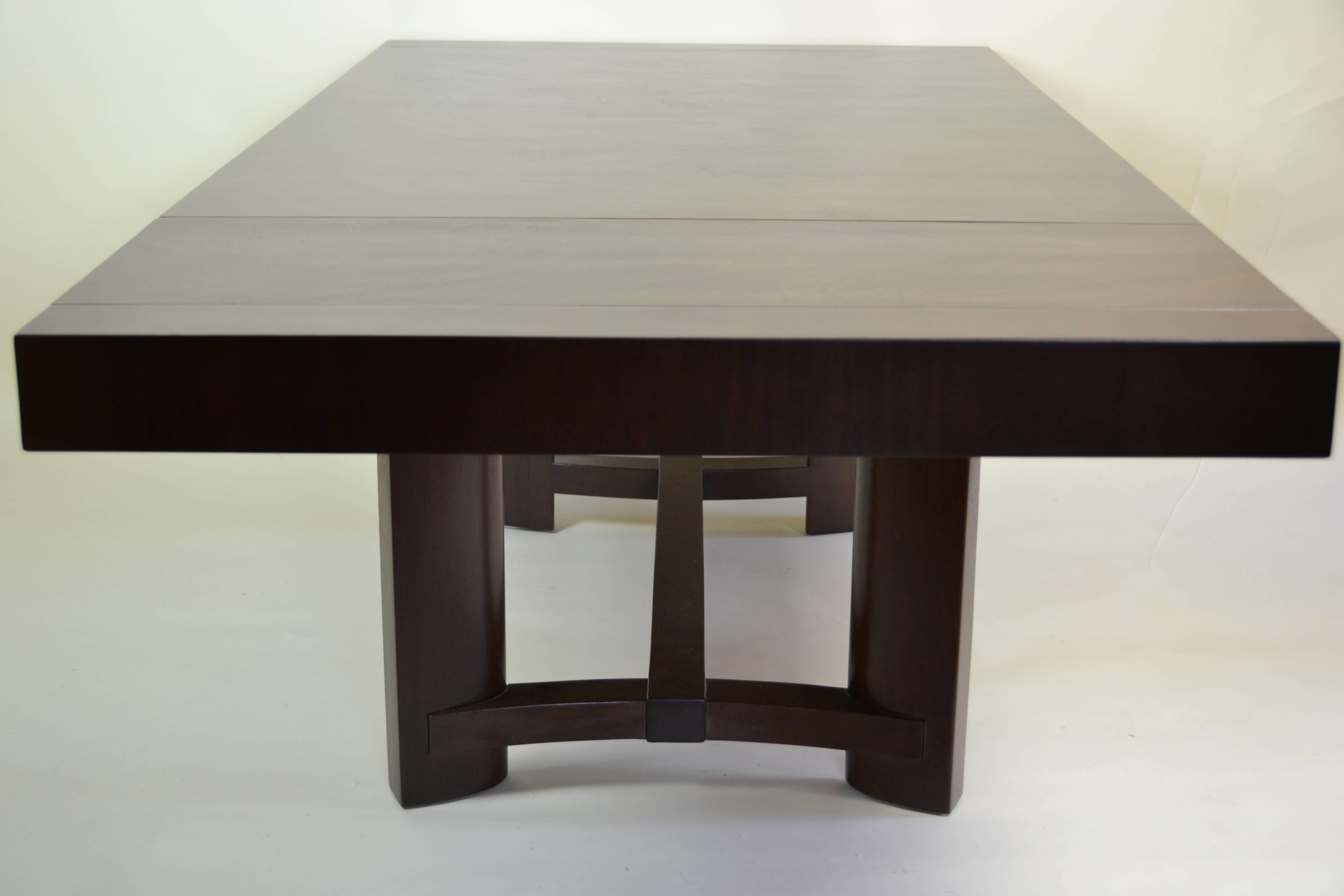 A Classic mahogany extension dining table designed by T.H. Robsjohn-Gibbings for the Widdicomb Furniture Co. in the late 1940s. Each end pulls out to add a 14 inch leaf. This extends the table from 66 inches to 94 inches.
The table is in excellent