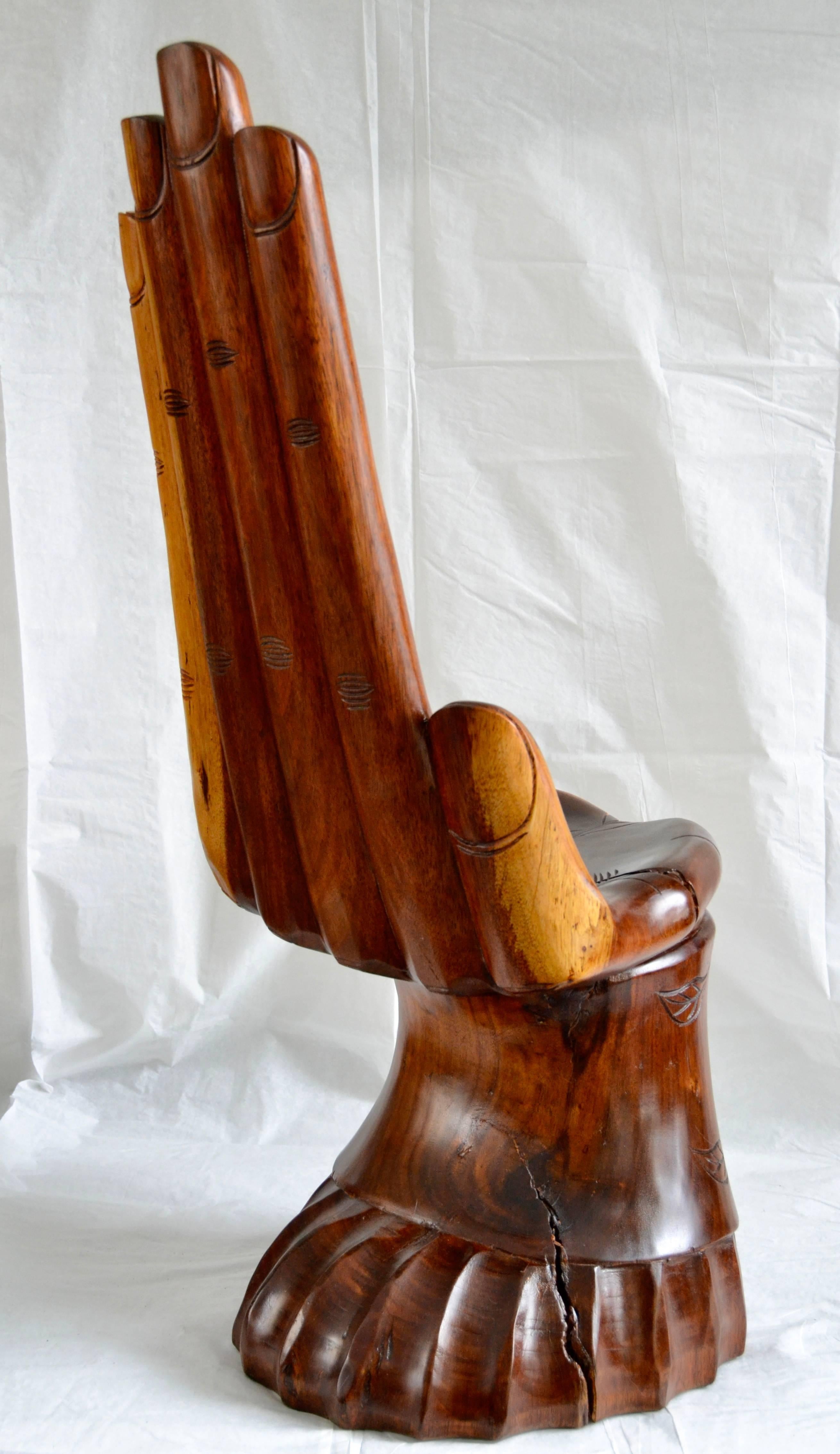 A finely detailed studio carved cocobolo hand chair crafted in Guadalajara, Jalisco Mexico, circa 1960. 
The Studio carved hand has an incised love line and life line. 
The artist has carved elegant fingernails and the inner and outer joint lines
