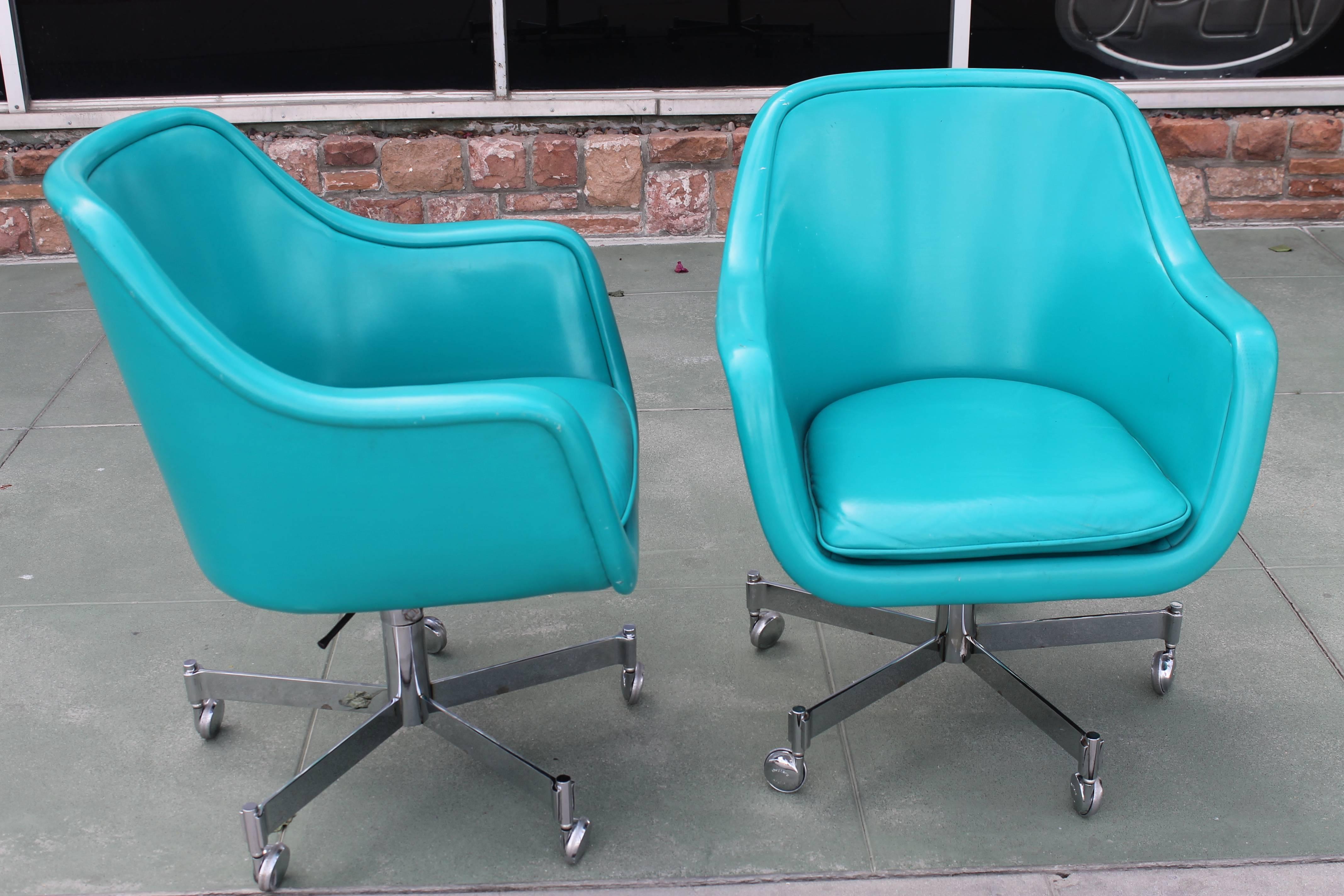 Pair of turquoise office chairs by Ward Bennett for Brickel Associates. Chairs tilt, swivel and are height adjustable. Both chairs show some wear. Extremely comfortable.