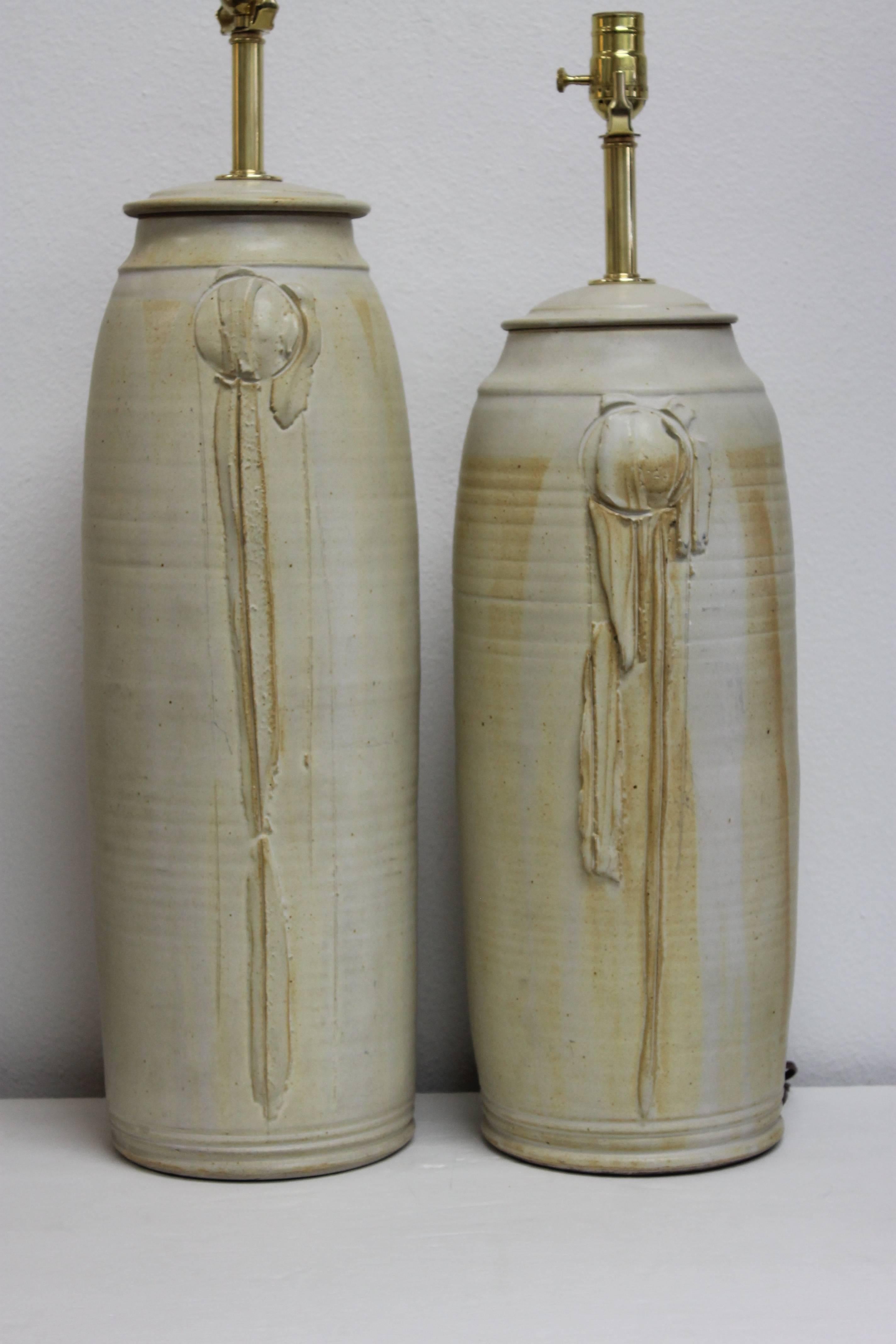 Pair of studio hand thrown lamps. The large ceramic portion is 23" high, 9" diameter and 26.5" from base to the bottom of socket. The smaller ceramic portion is 20.5" high, 9" diameter and 24" high from base to the