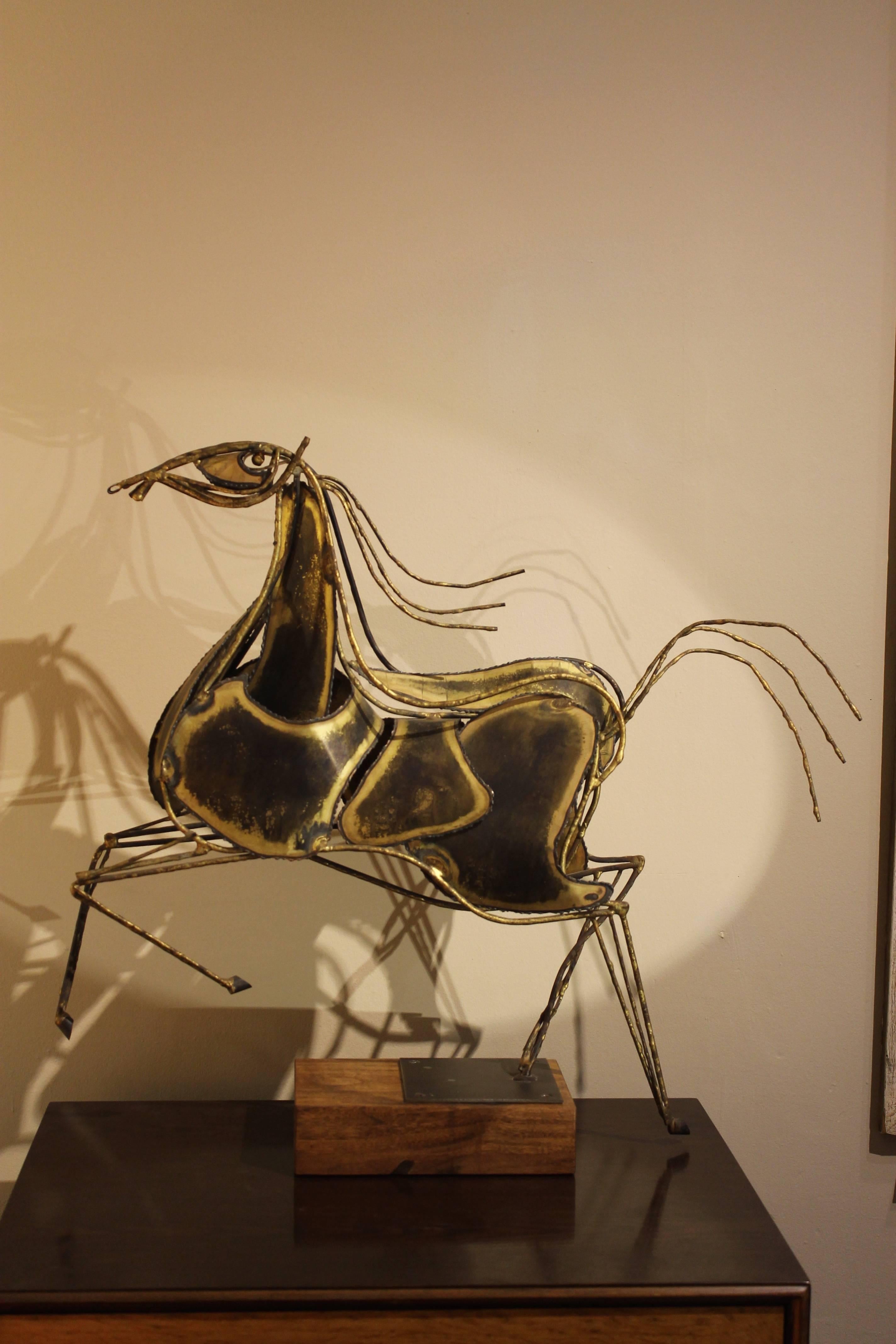 A large and impressive modernist sculpture of a horse by Curtis Jere, circa 1960s. Material is brass plated steel mounted on a solid walnut block base. This piece is not signed as far as we can see. The walnut base is a replacement we believe and