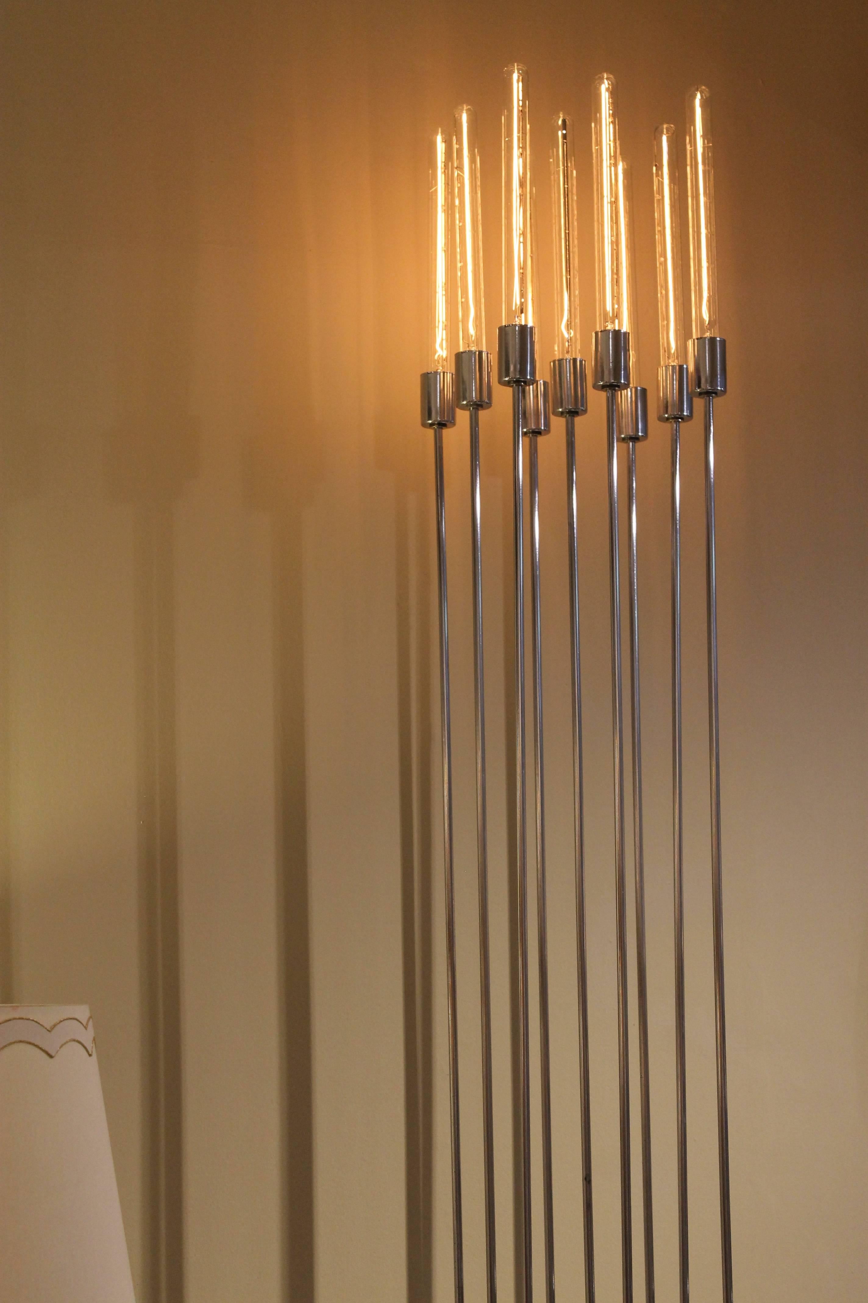 A super elegant chrome and marble torchiere / floor lamp featuring nine vertical chrome rods rising from a black marble base. Twelve inch tubular 25 watt bulbs enhance the striking verticality. An in-line dimmer switch enables you to display at any