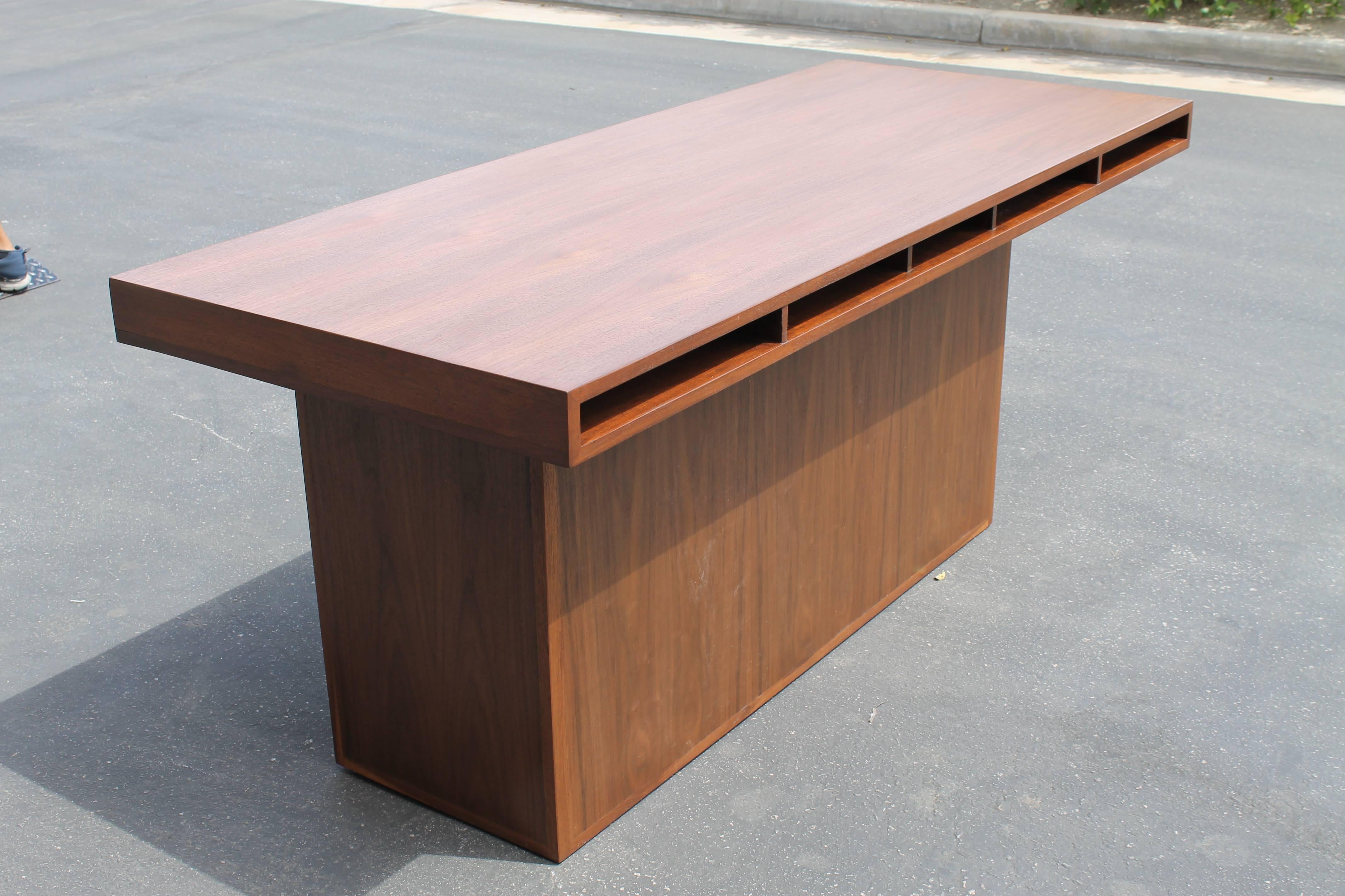 Beautiful desk signed Maria Bergson, October 1949. Desk was restored in walnut veneer. Single leg is our addition to this wonderful piece. It originally had a wood cabinet but, when we found it…it had a metal throw away cabinet which we discarded.