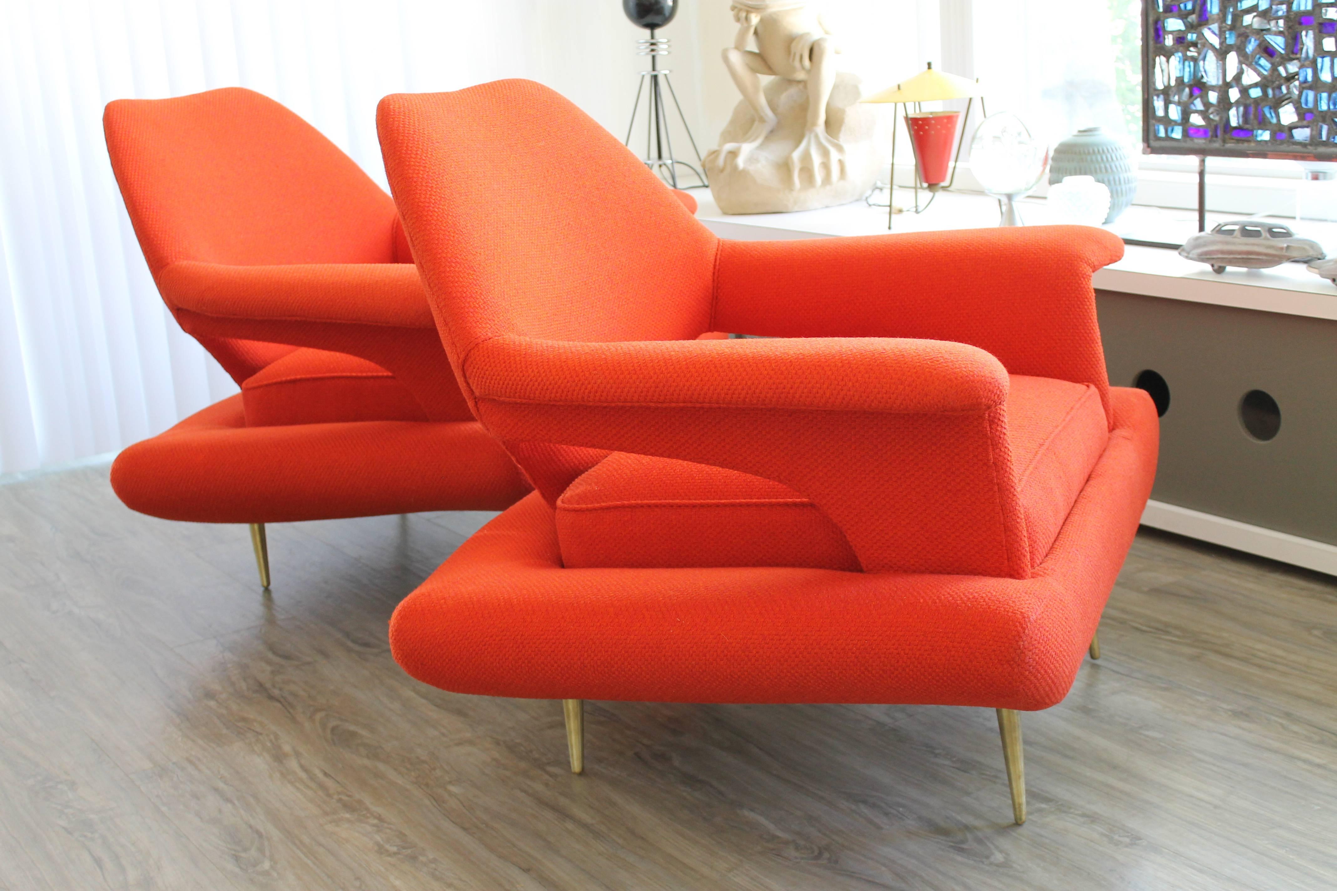 A stunning pair of highly sculptural chairs with solid brass tapered legs. Recently reupholstered. Color is a reddish orange. We believe these to be of European origin and design, most likely Italian. Possibly by Gastone Rinaldi. They are