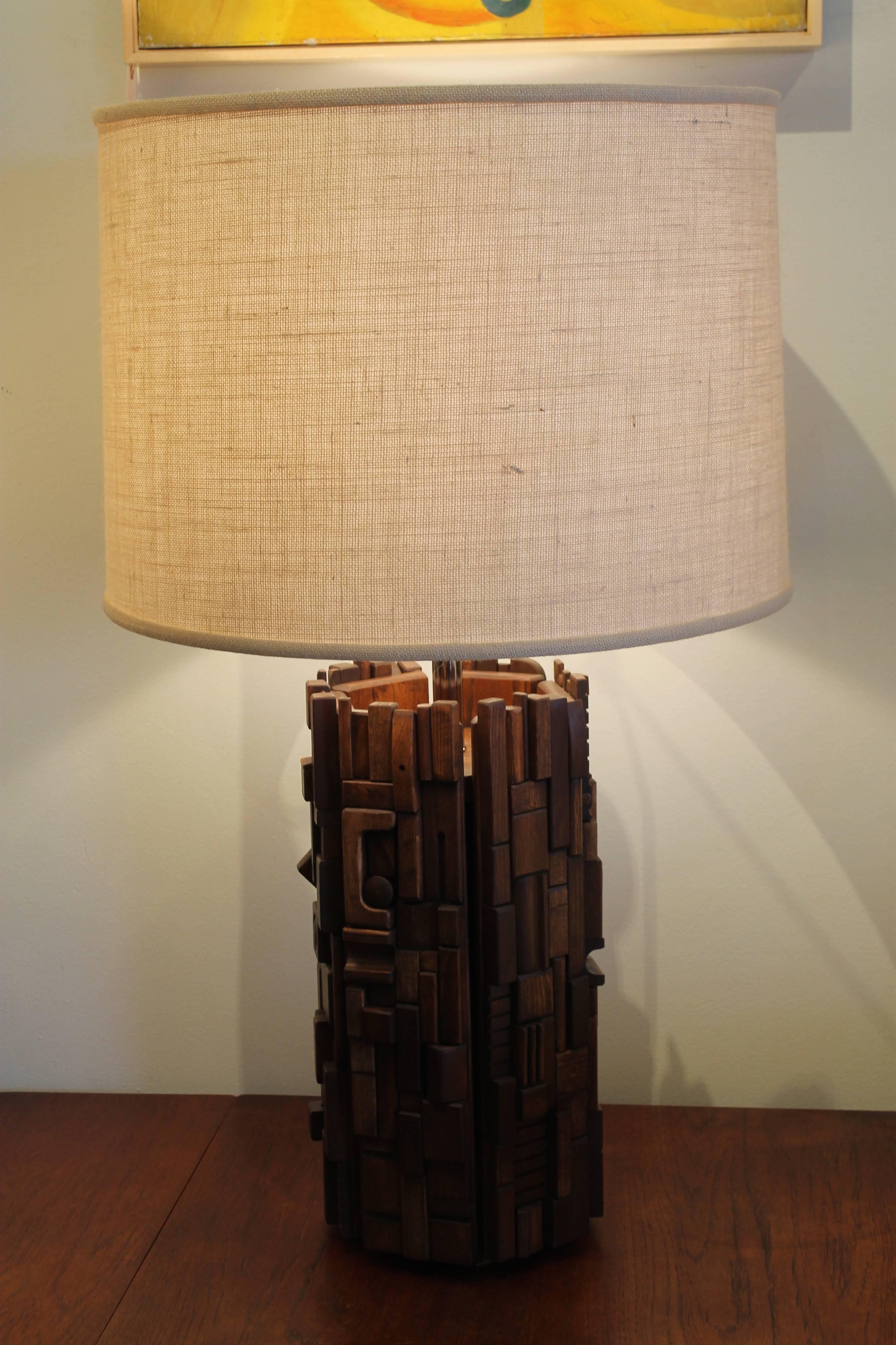 A monumental table lamp consisting of six rectangular panels each covered in hand cut and carved hardwood pieces. Each panel is different. Unsigned but clearly the work of Mabel Hutchinson circa 1960s. Overall height is 37