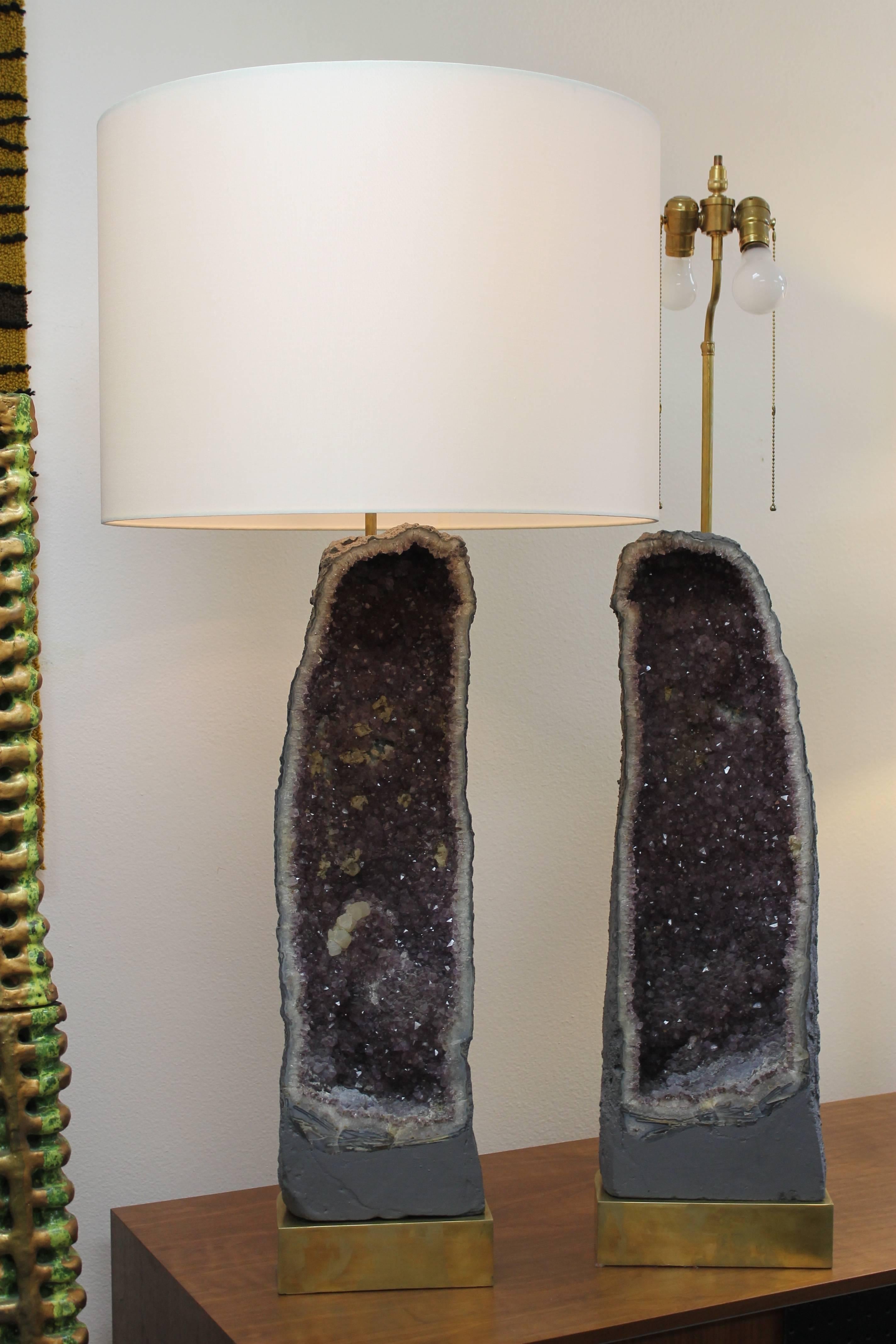 Monumental pair of custom amethyst geode lamps. They measure 48” total height from base to the top of shade. Geode is 9.5” wide and 28.5” high. Base is 10” wide, 8” deep and 2.75” high.  Lamp shades ARE included.