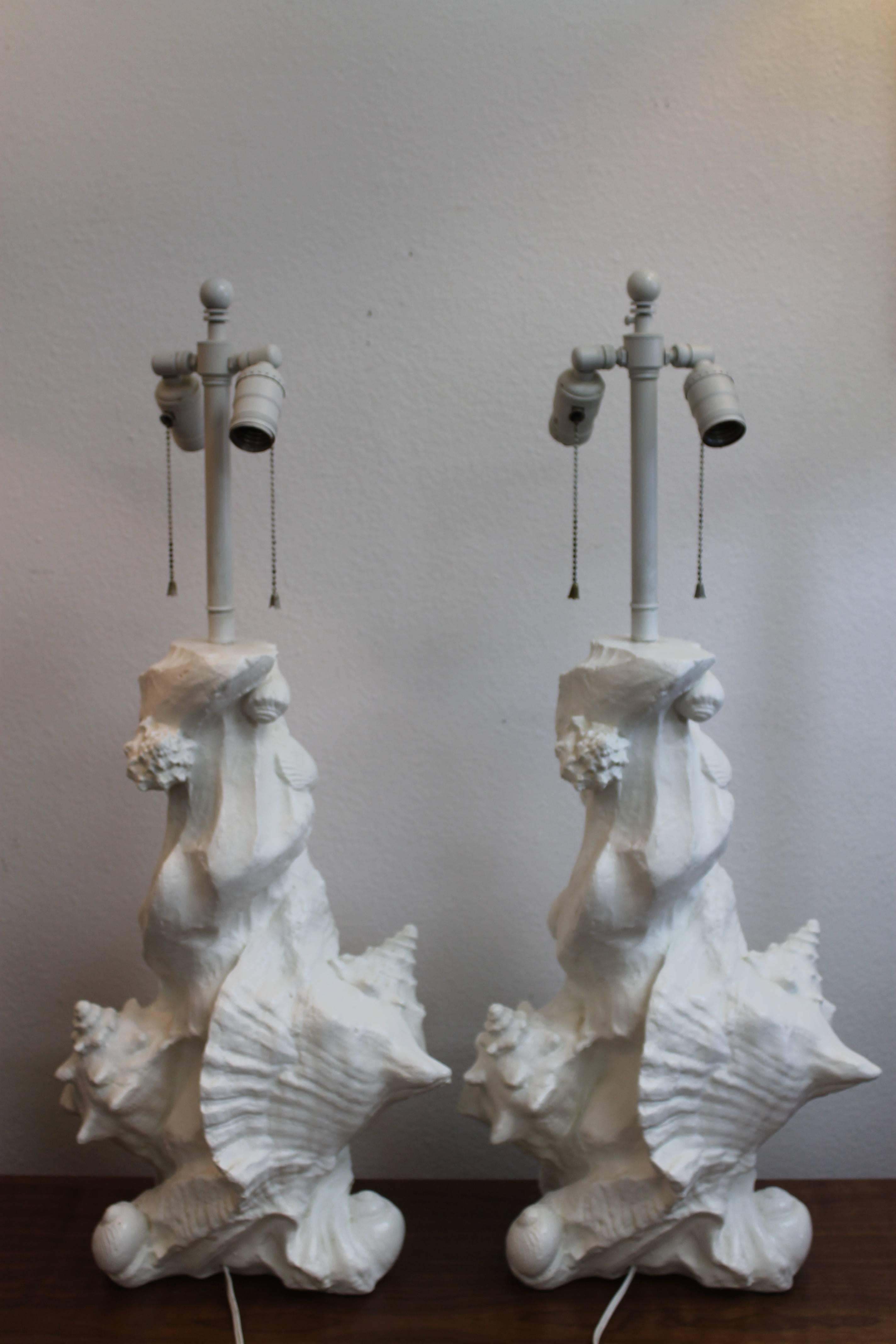 Pair of seashell or nautical lamps attributed to Jacques Grange for Sirmos.  All original including double sockets with adjustable stem harps.  Plaster portions are 19.25