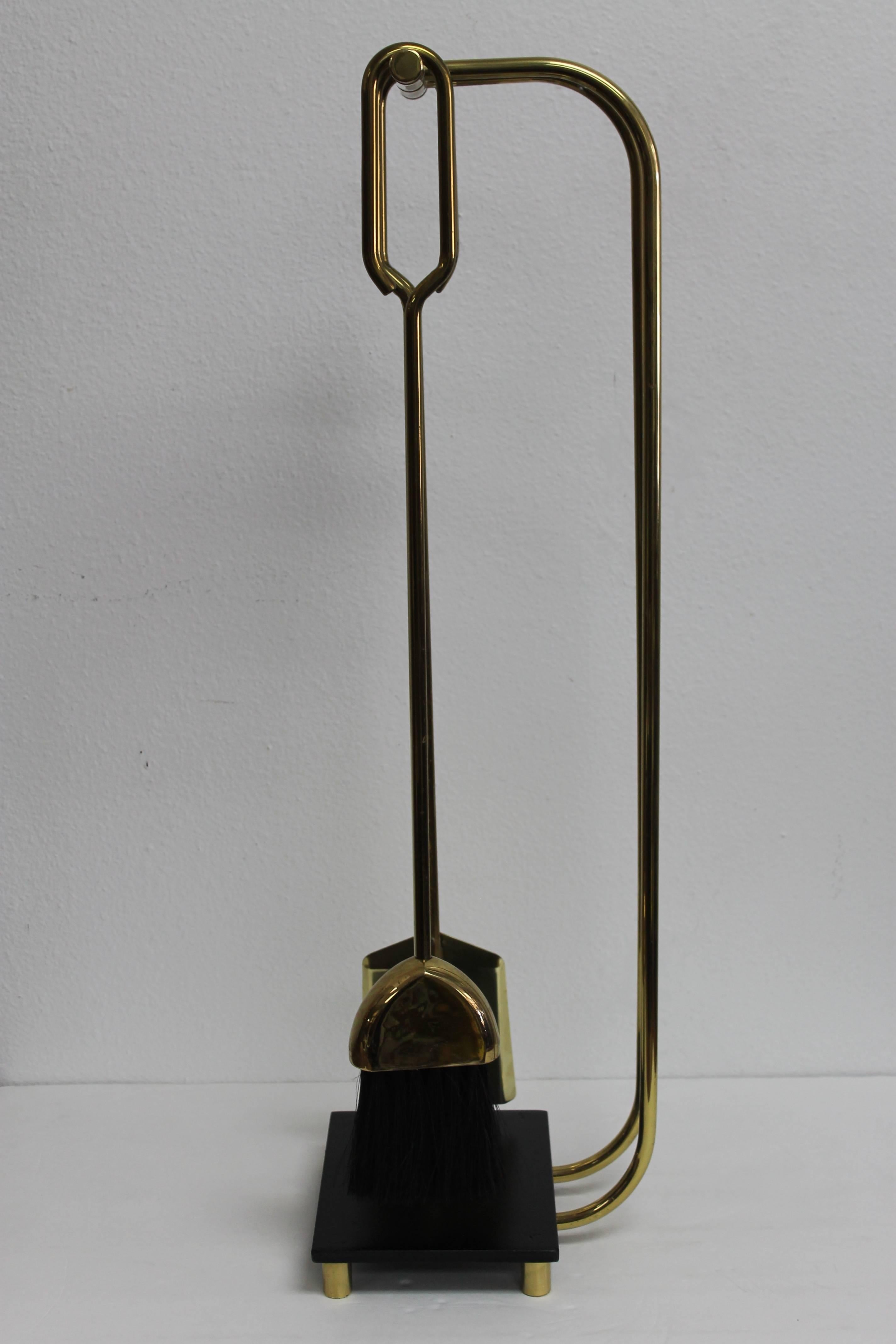 Elegant brass midcentury fire place fire tools. Base is 8” wide, 6” deep and 1.5” high. Tools are about 28” high. Total height when tools are in place is about 30". Tools have been polished and base has been repainted to its original black