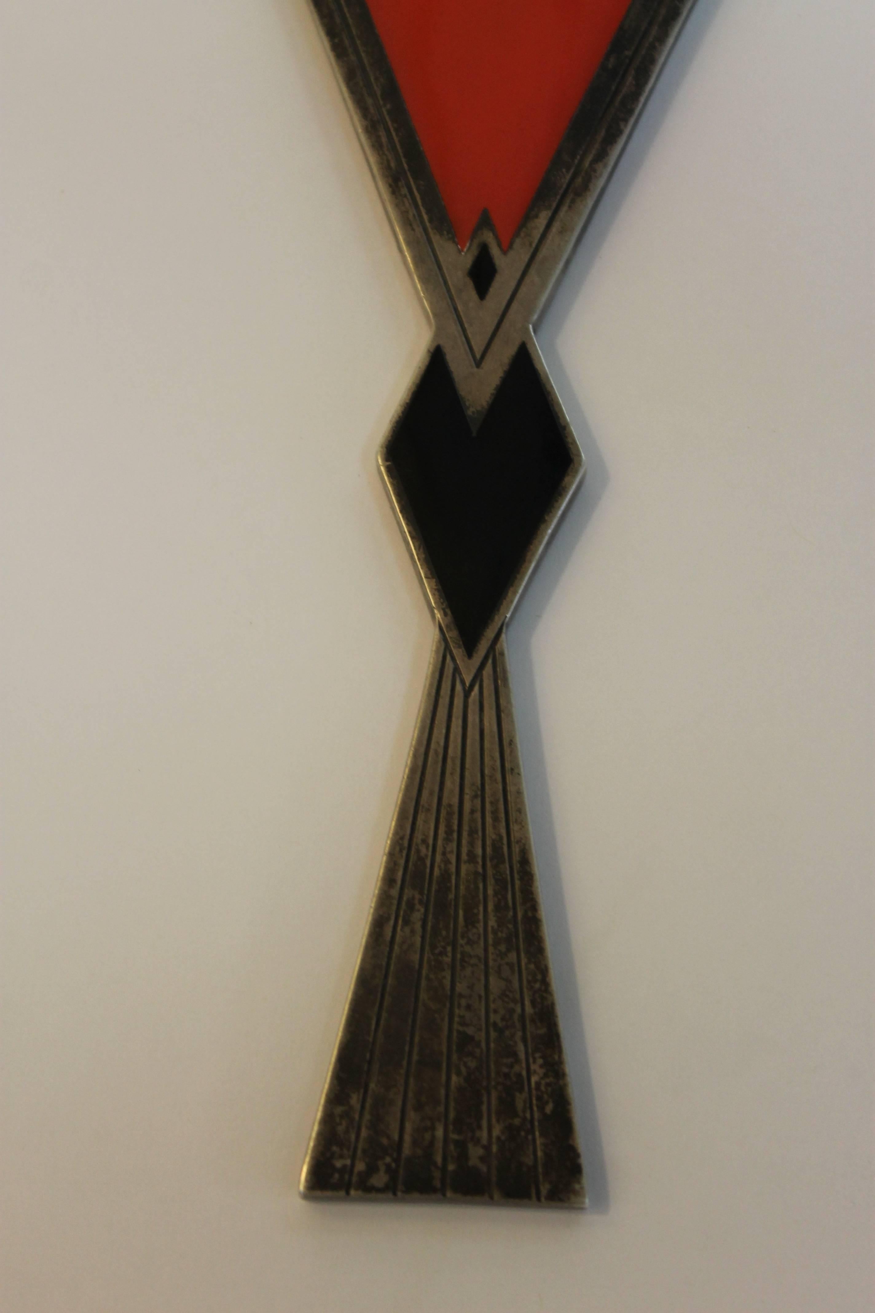 A sterling silver hand mirror in the Art Deco style with coral-red and black enameling and a beveled triangular mirror, circa late 1920s, we believe this design to be the work of Elsa Tennhardt but we have seen no other examples. Clearly marked