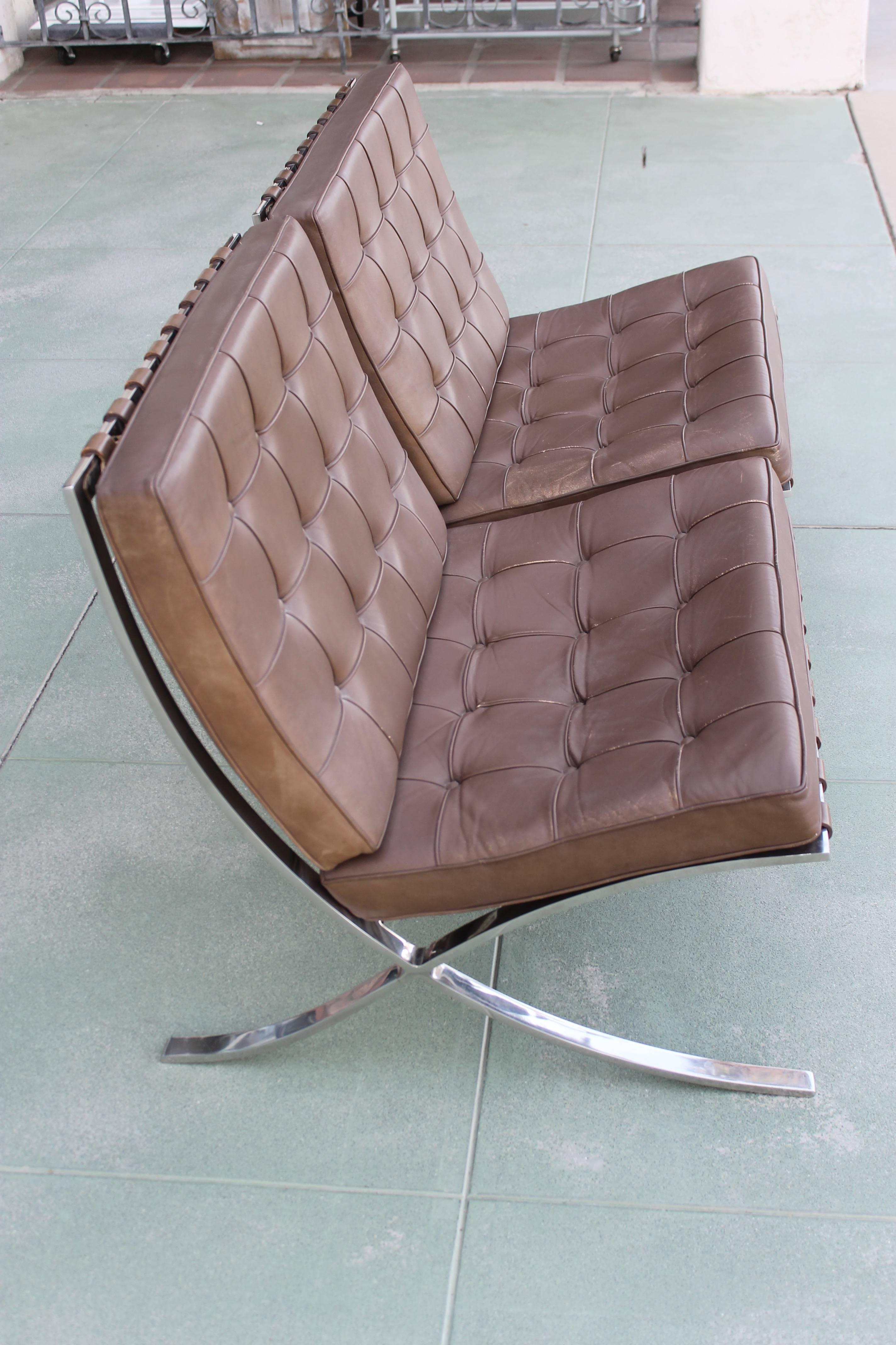 Pair of Barcelona chairs by Knoll in a brown leather. Chairs have Knoll labels and one of them has a date of 1974. Chair frame measures 29.25