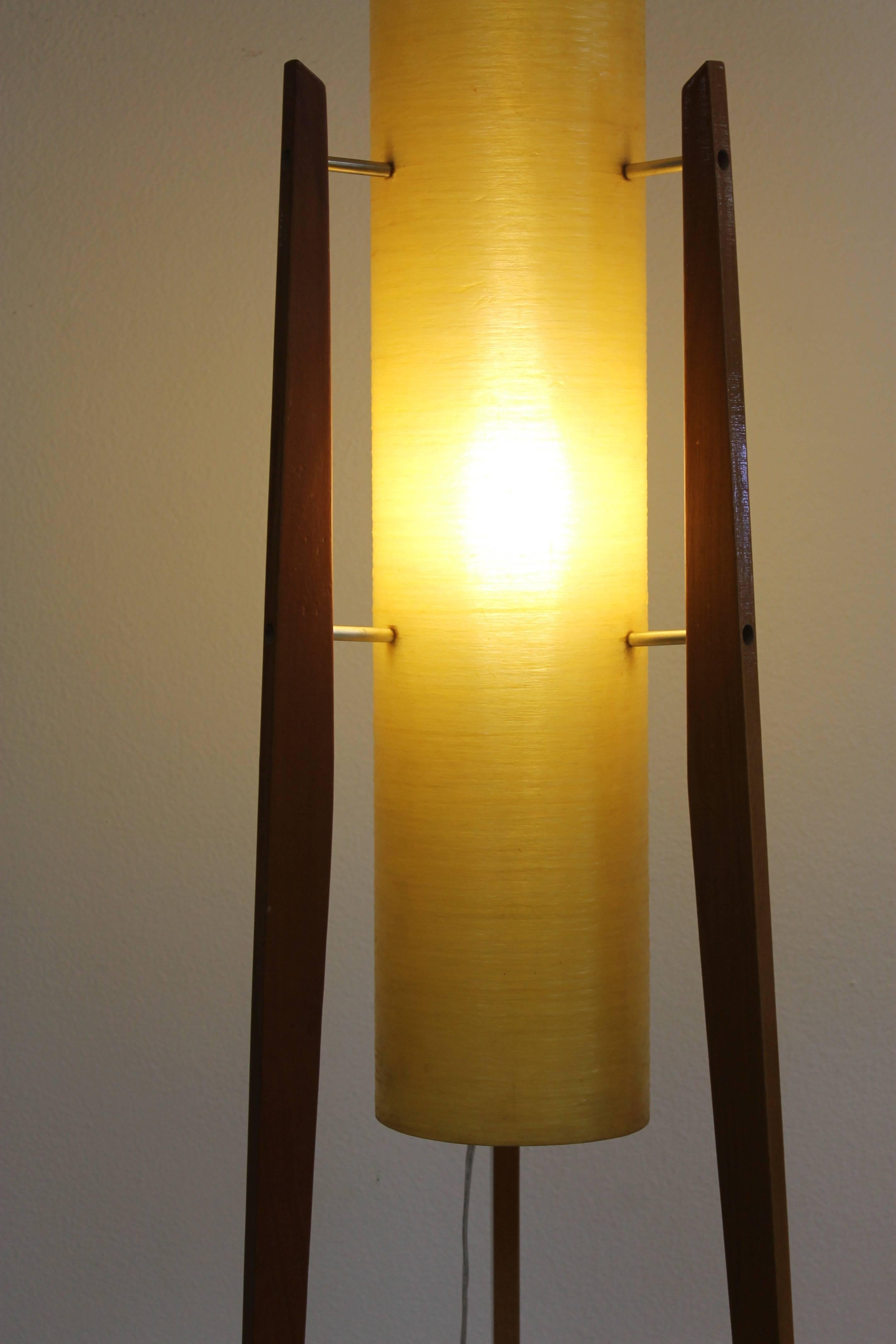 Found in Czechoslovakia, this lamp features a cast resin cylinder in muted yellow supported by three tapered hardwood legs. Beautiful yellowish glow is similar to that of spun fiberglass lamps of the same period. The lamp measures 46.25