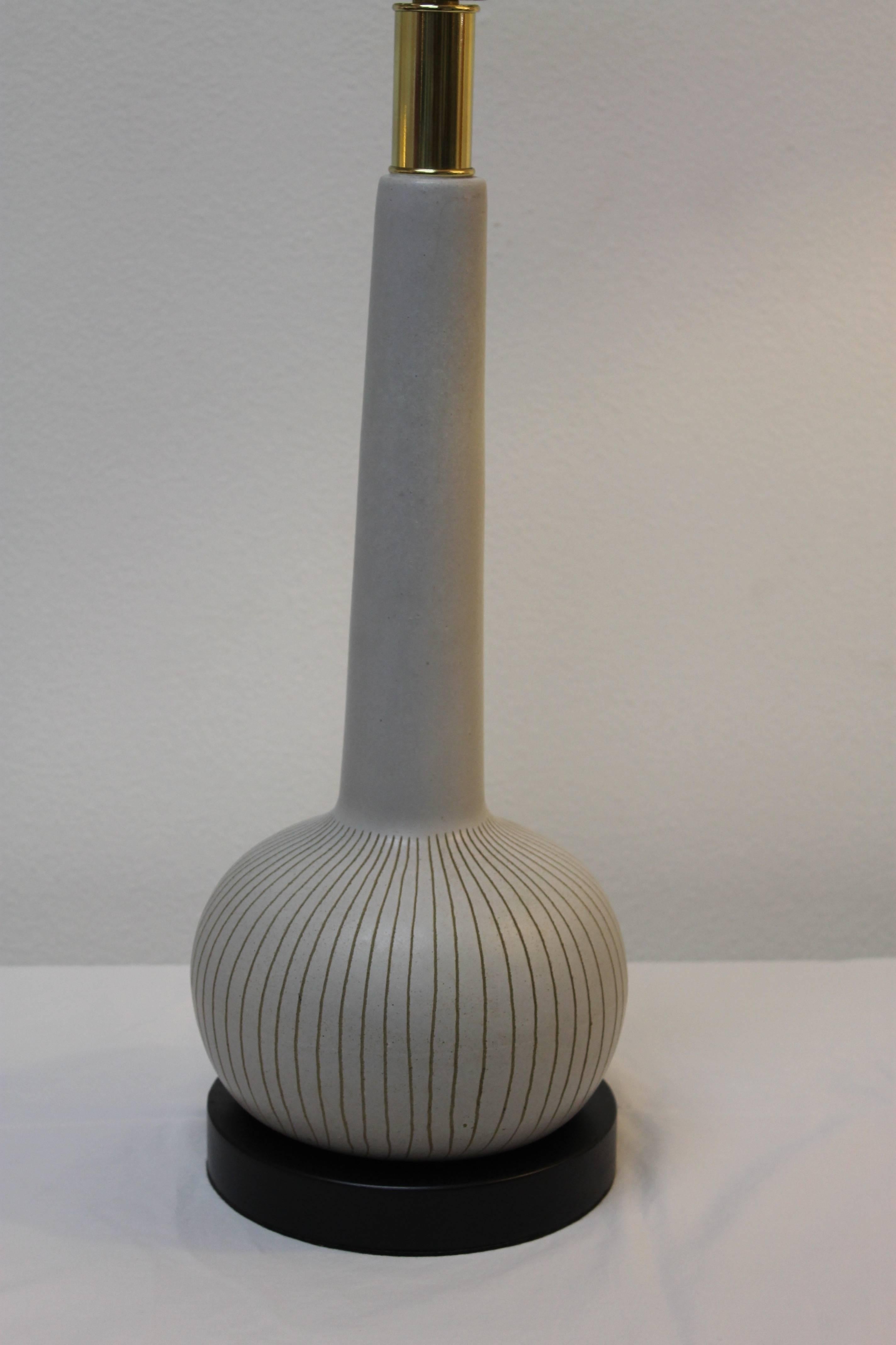 Bulbous Martz lamp newly updated. We added a new black wood base, brass neck and newly rewired. Measure: Ceramic portion is 15.5" high and 75" diameter. Wood base is 7" diameter. Total height from base to the bottom of socket is