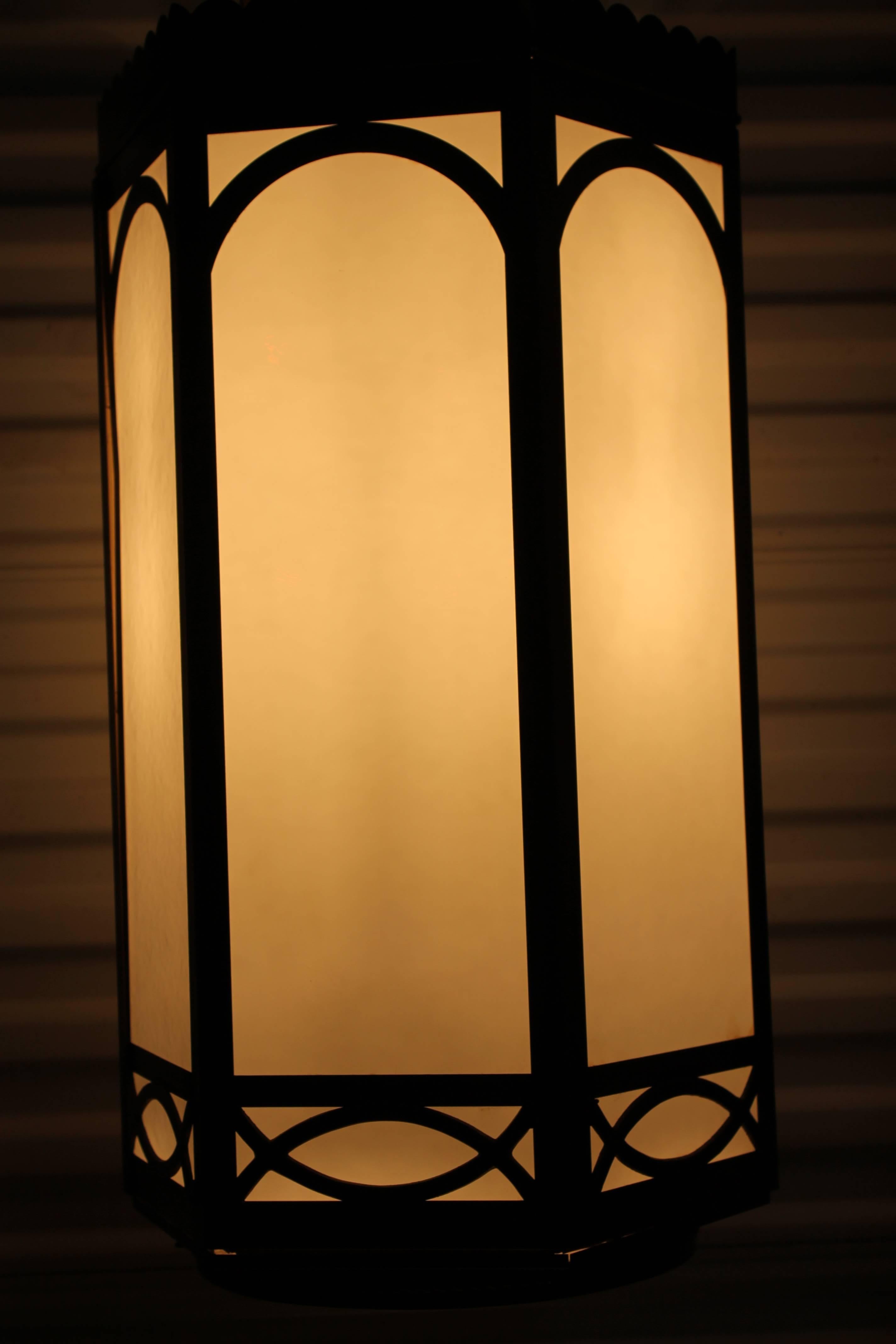 In true Gothic fashion, these lamps illustrate the style of light common to many cathedrals of the time yet devoid of any religious symbols. Lights are of grand scale consisting of six sides that hold milk glass panels. Inside the electrical