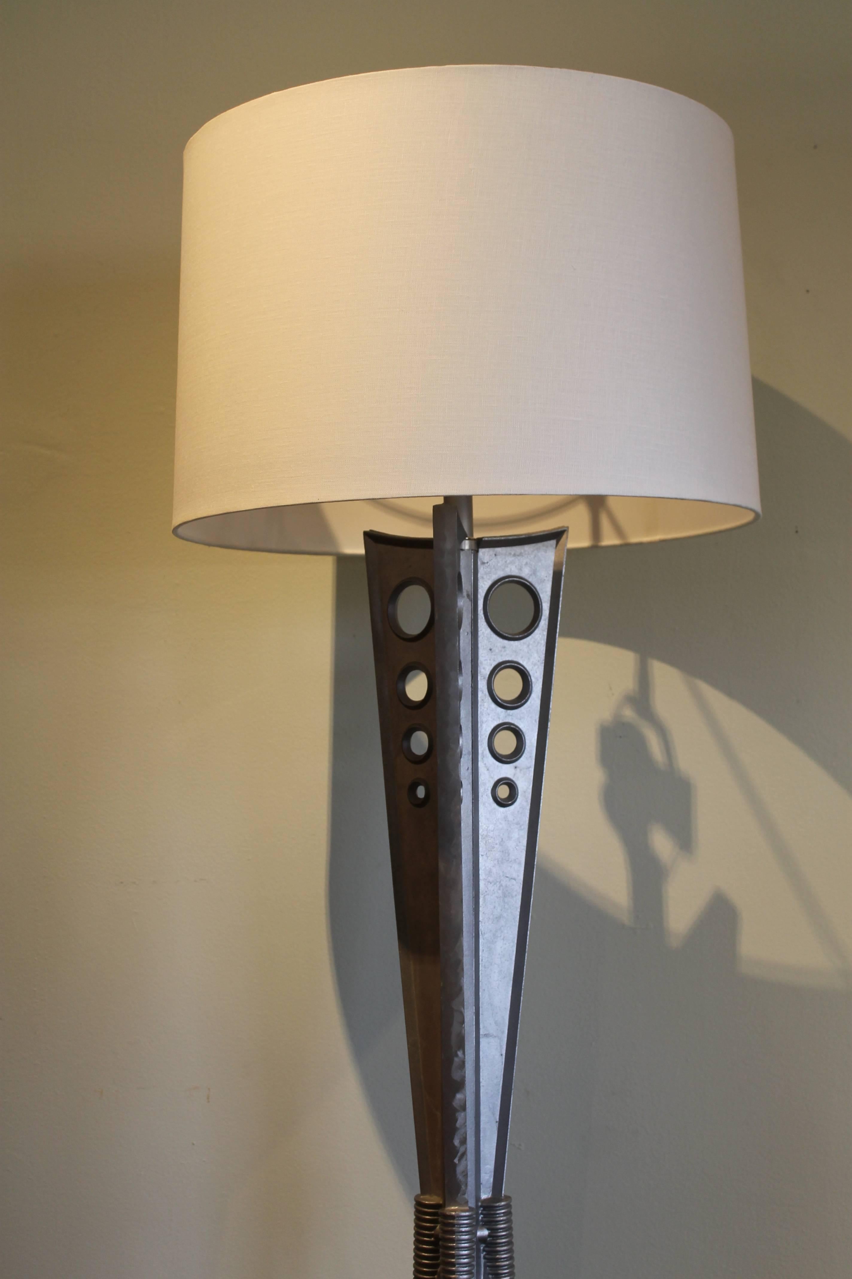 Space age aluminum floor lamp, maker unknown. Lamp originally had an aluminum dish. We decided to modify it by adding hardware and 3 way light switch. We also added the 3 bars that connect the base (3 circles). Lamp base is about 15