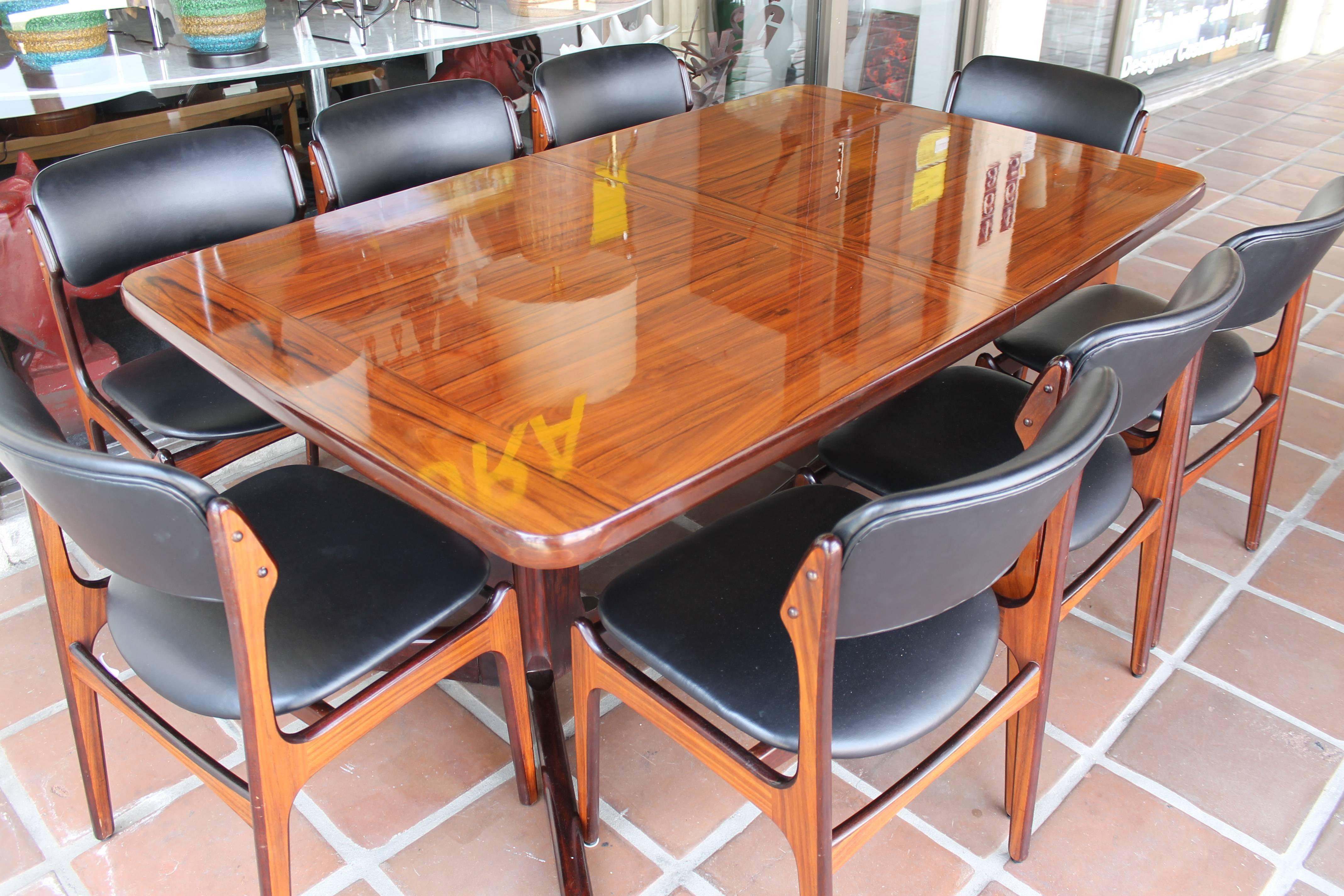 Incredible rosewood table and chairs. This set consists of 12 pieces (table, eight chairs, two leaves and stand for leaves). Table is about 9 feet wide with both leaves in place. Current picture of table measures 68.25” wide without leaves, 41.75”