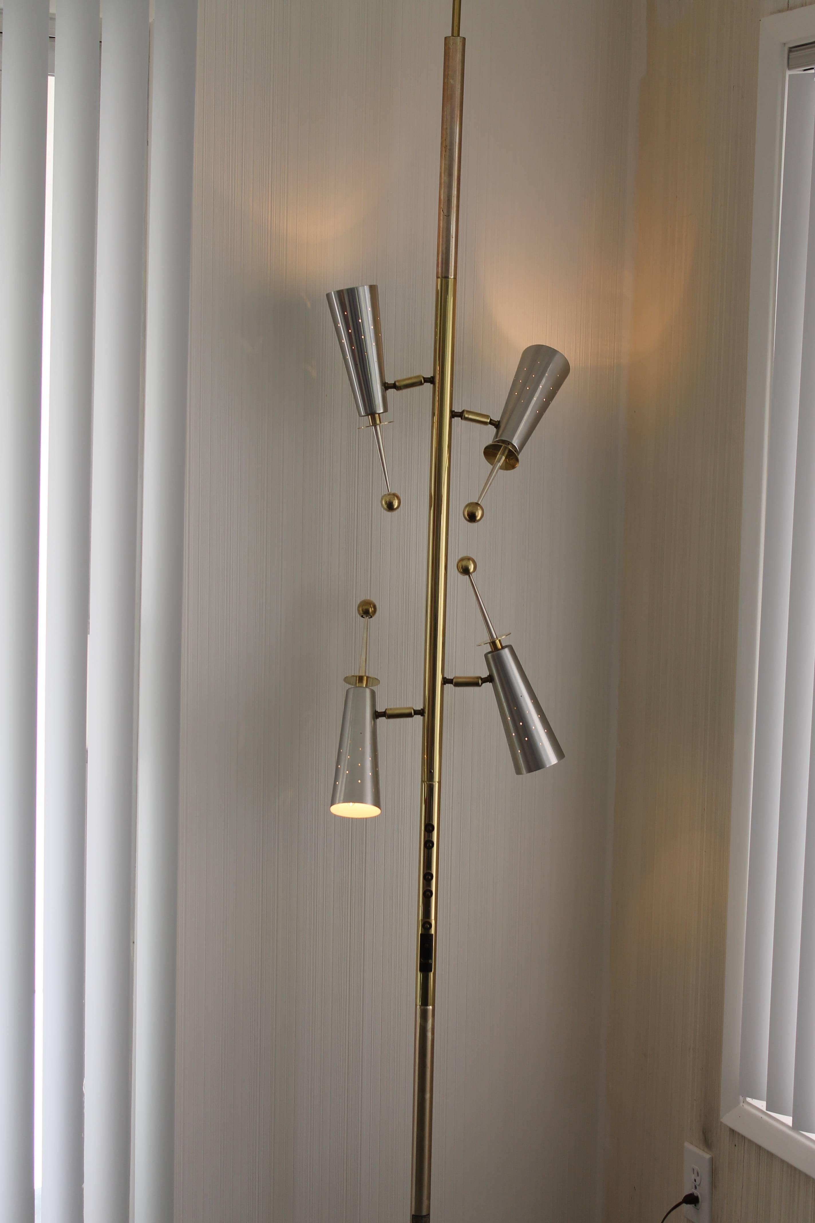A super clean example of Stiffel's top of the line pole lamp from 1959. There are four fully adjustable mixed-metal perforated cones, made of brass, aluminium and silver alloy. Cones measure 13.5" long including the handles and 3.25" wide.