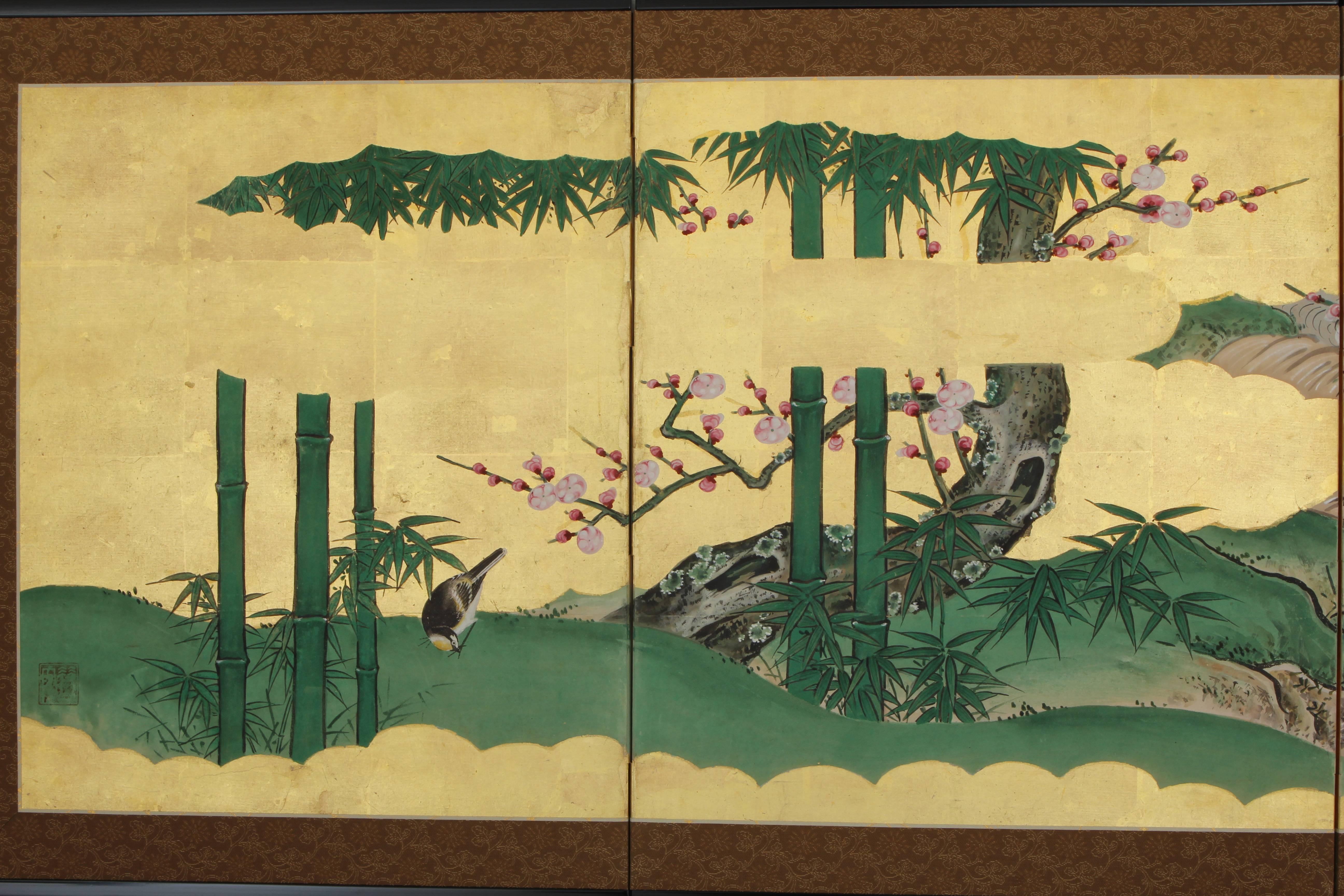 Six-panel folding screen with a scene of birds flying over a flowering plum and bamboo by a stream. Painting in ink and mineral colors on paper with gold leaf. Artist's square seal mark. Mounted with a silk-brocade border and framed with