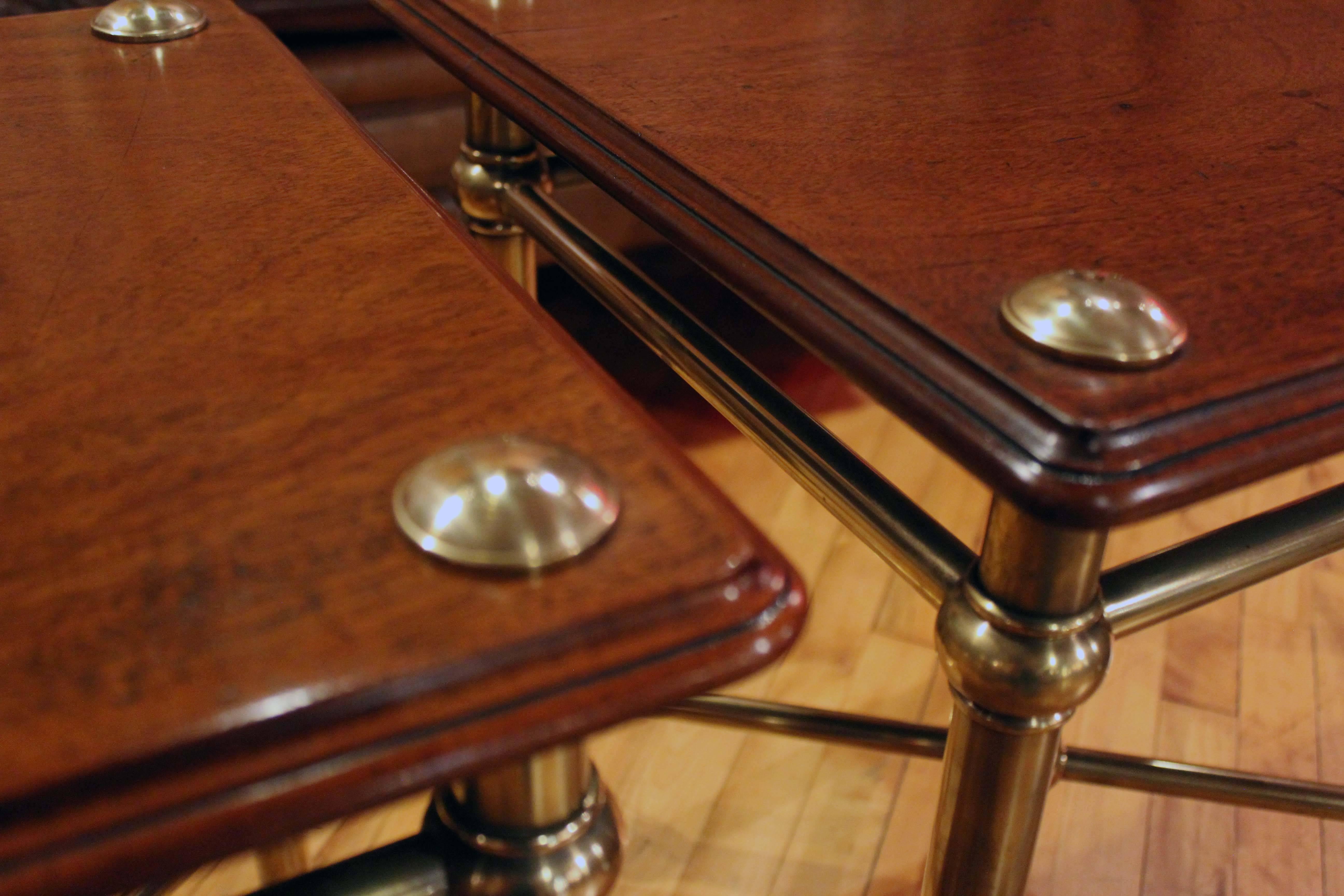Pair of English mahogany and brass trolleys with X-stretcher.