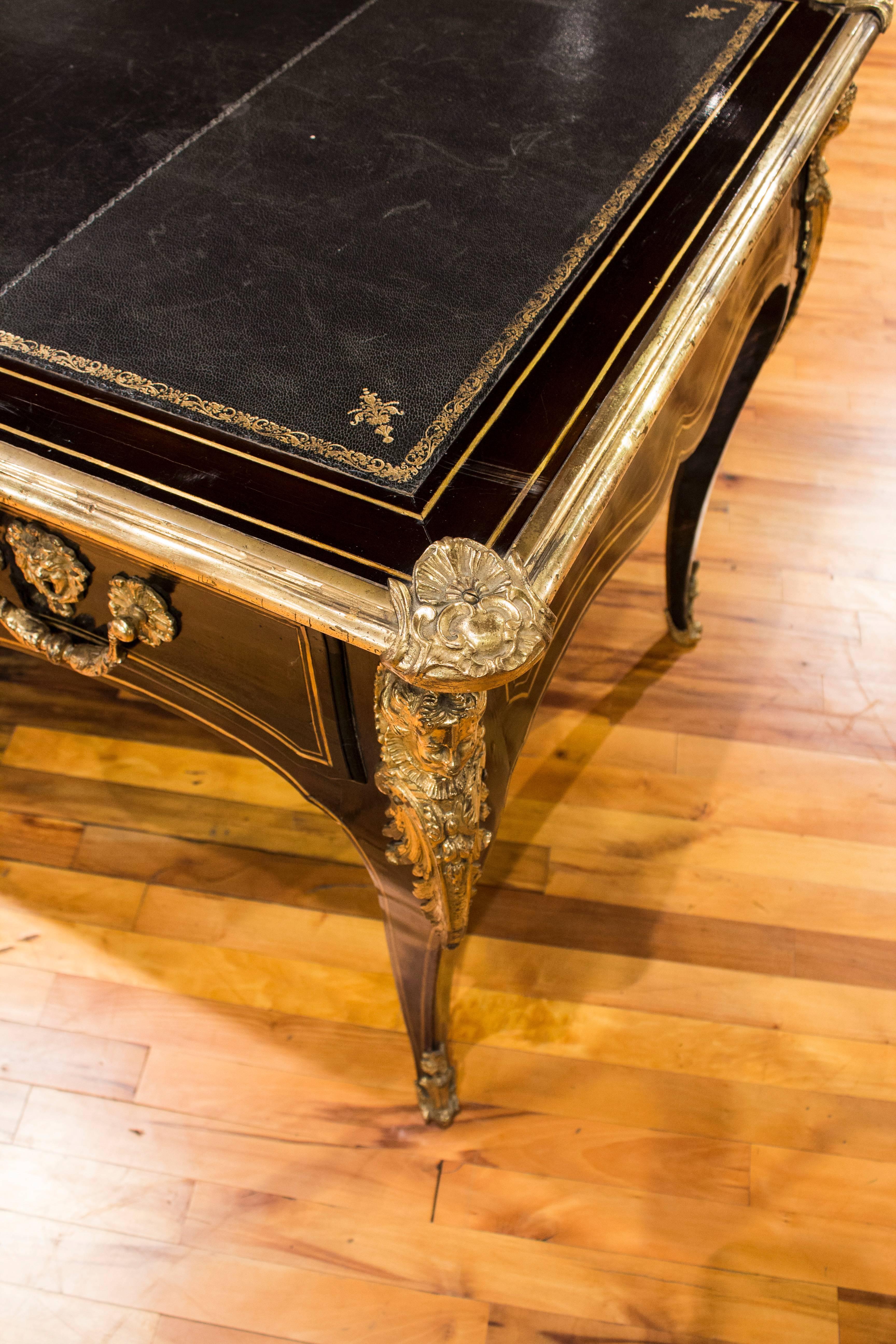 French bureau platte dark brown lacquer with brass discussions and pulls.