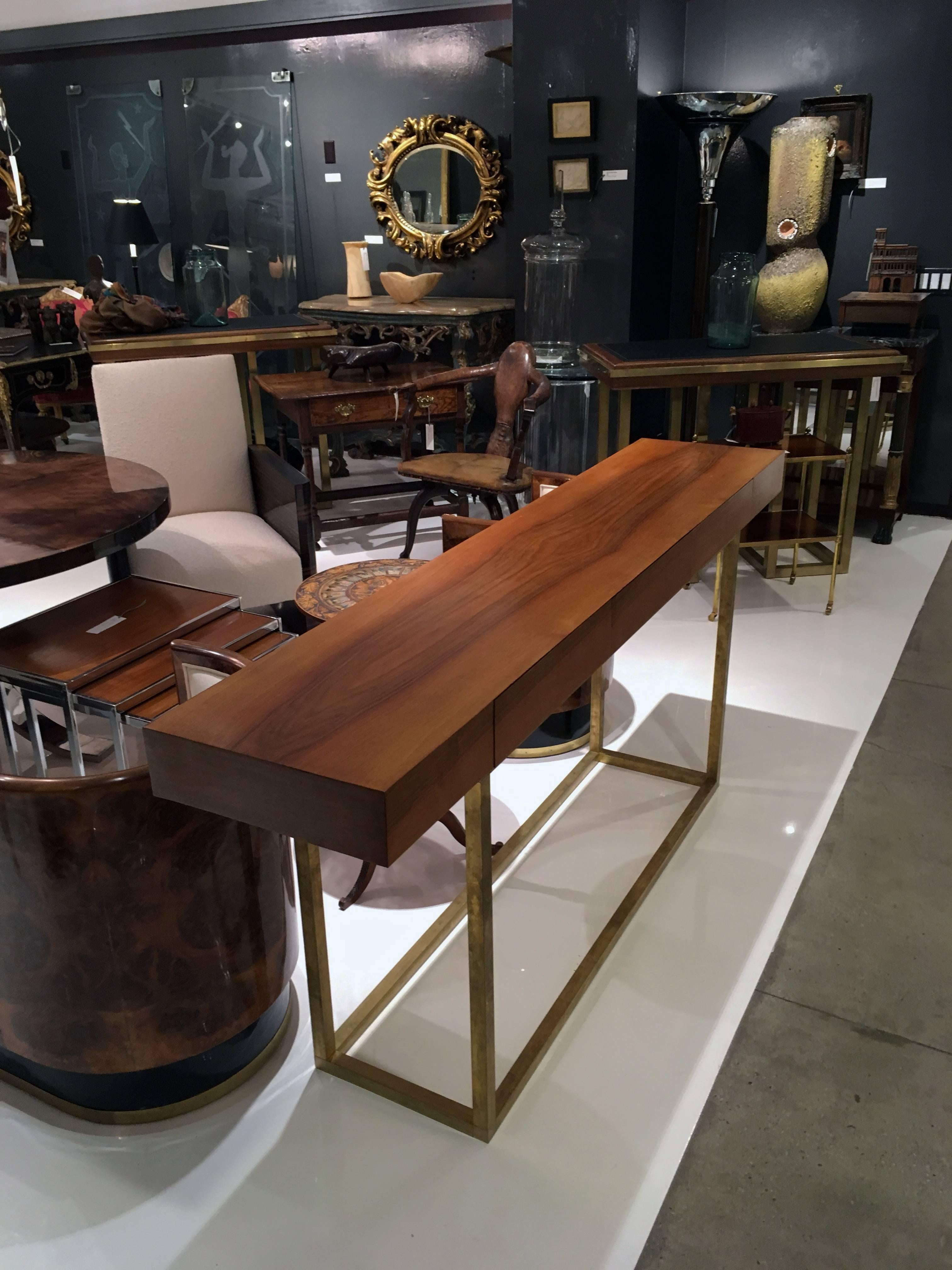 Italian wood top and brass leg console table with three drawers.