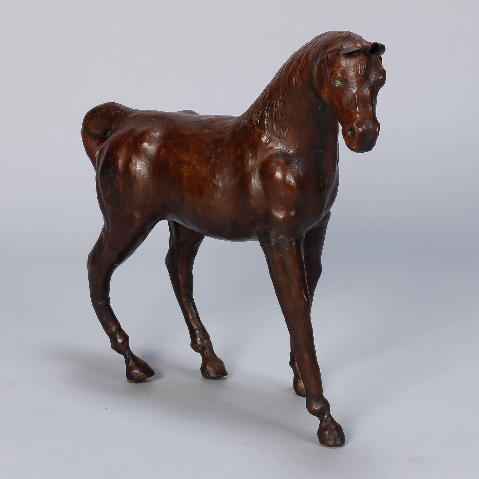 Circa 1970s horse form is covered in rich brown leather. Nice size at over two feet tall and long.
