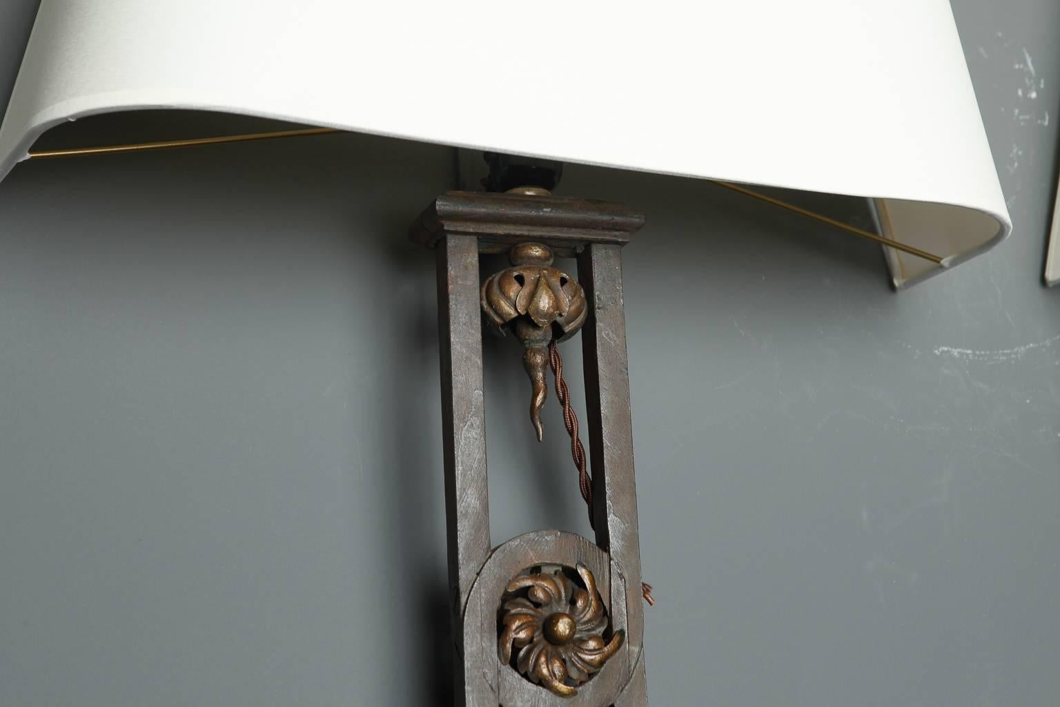 This pair of iron wall sconces is just under two feet tall. The sconce bases are made from 19th century antique iron balustrades. Shades are available for a separate charge. Sconces have been rewired for US electrical standards. Sold and priced as a