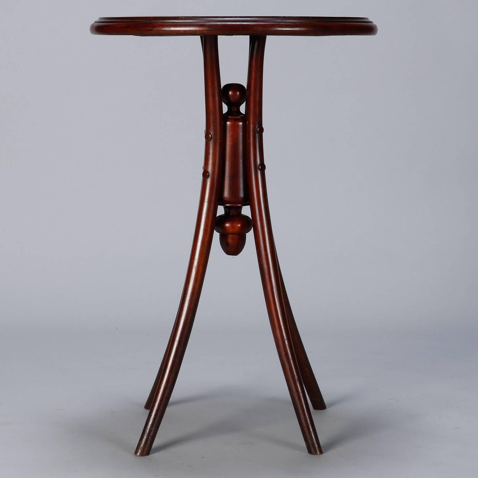 Thonet round side table with four legs and decorative center support, circa 1920s. Veneer on tabletop shows wear and some lifting. Some visible wear to legs.

 