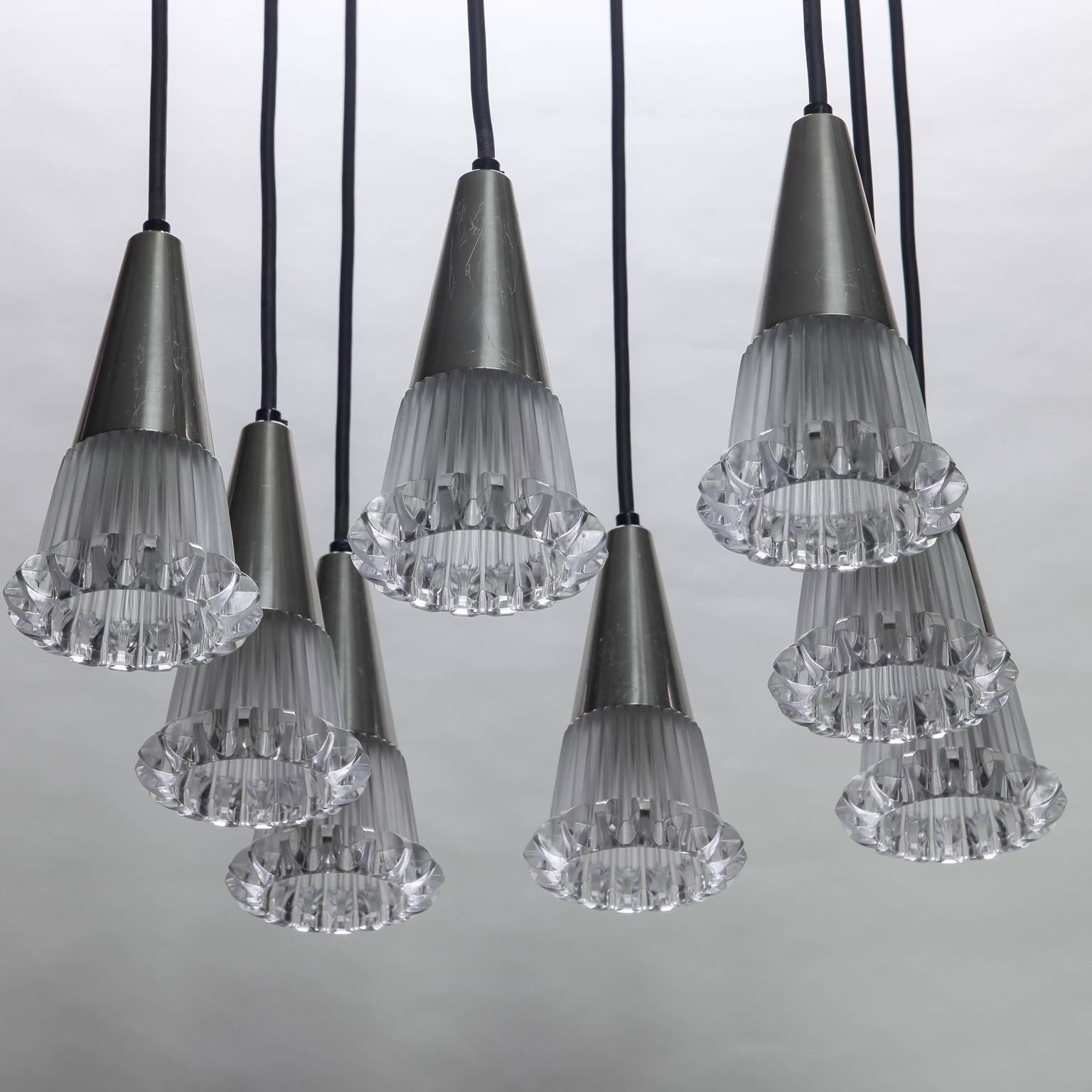 Mid-Century light fixture with eight clear molded glass cone ridged edge pendants hung in circular spider shape. Arteluce style - Probably Italian.
 