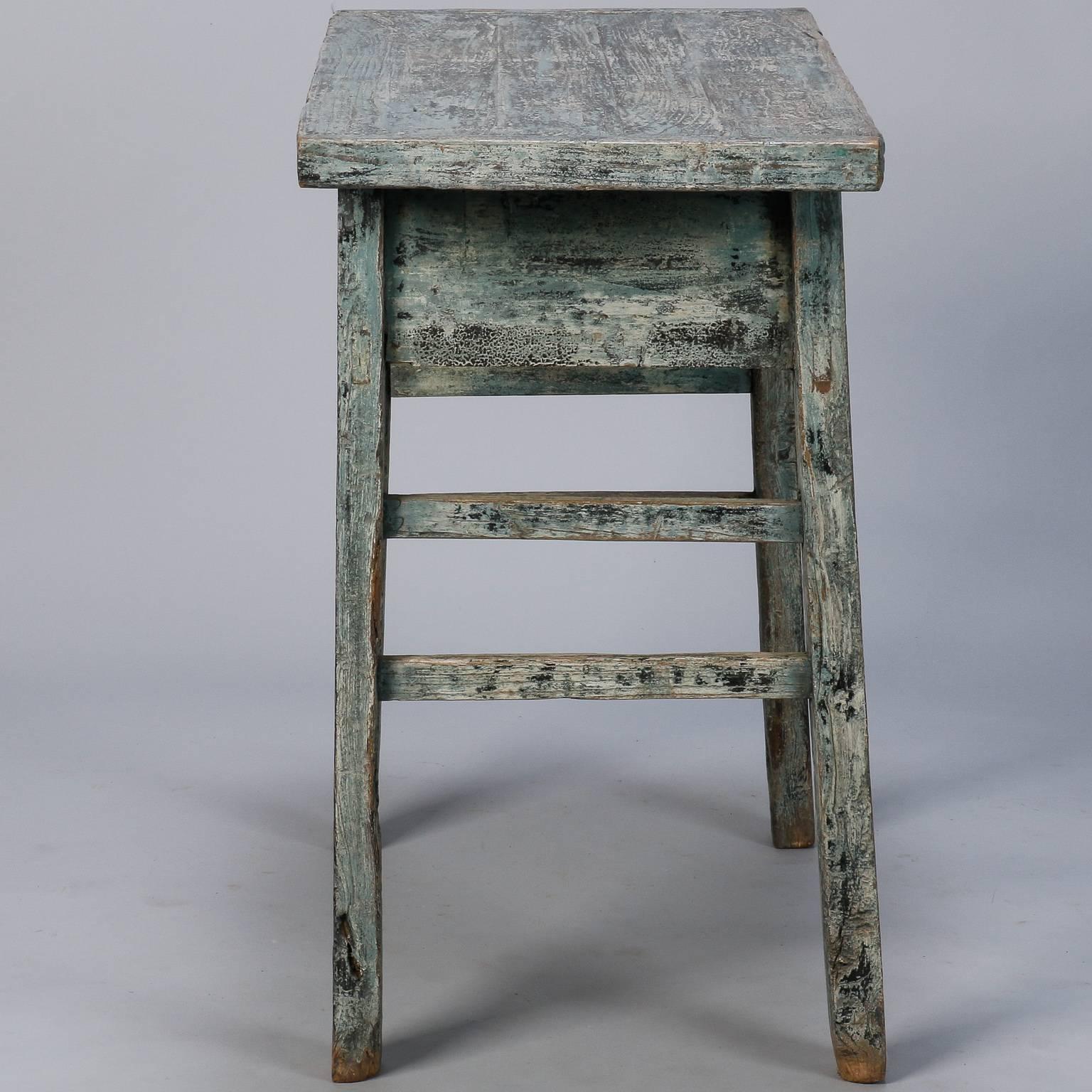 Circa 1920s small rustic Chinese table with two functional drawers and blue painted finish. 