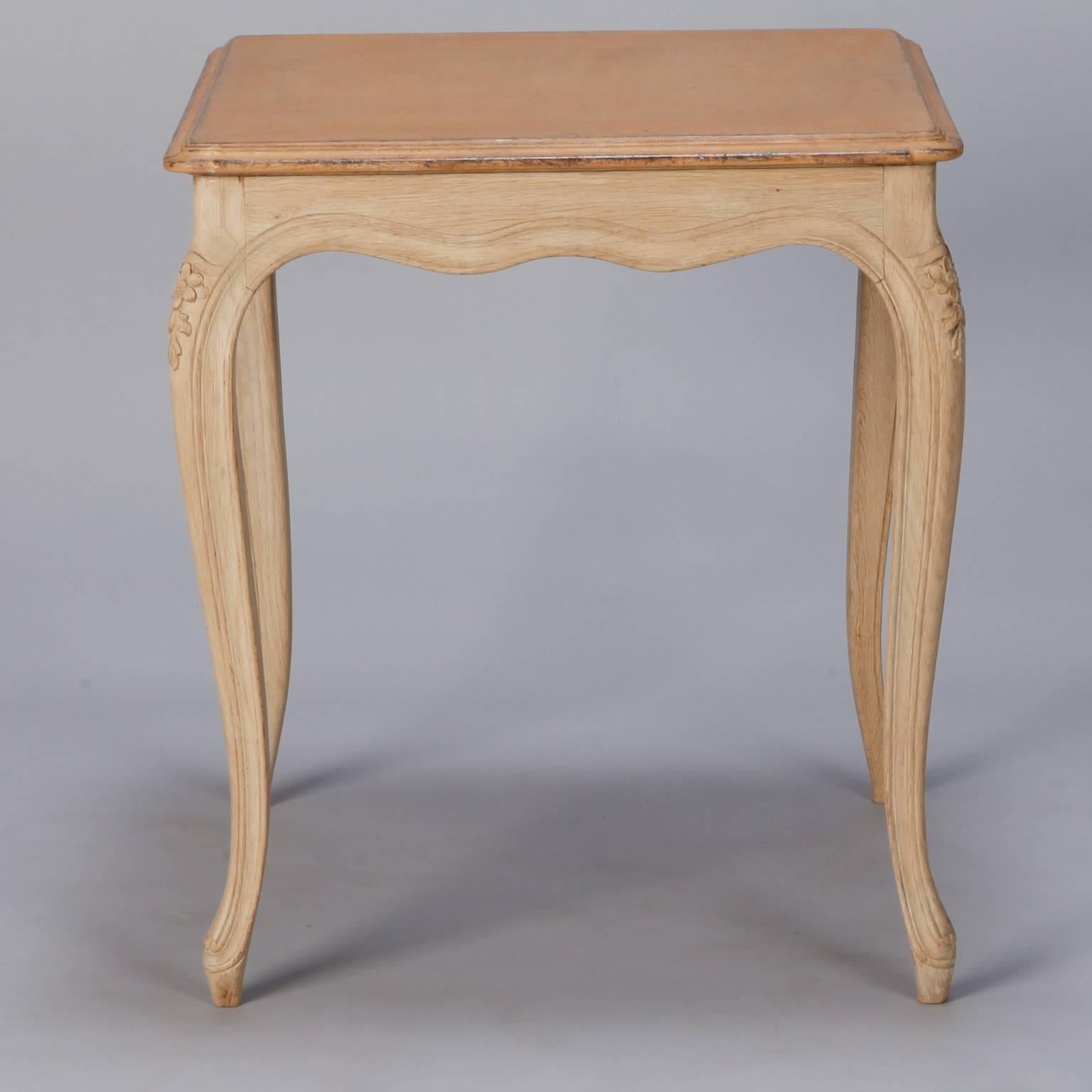 French square side table with painted top and contrasting bleached wood legs and apron with carved floral details, circa 1930s.

     