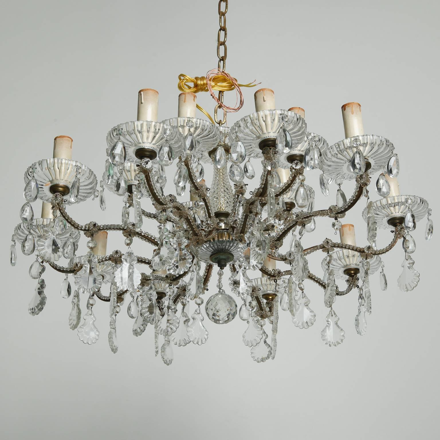 French chandelier has 15 candle style lights and a fixture height of just 12”, circa 1930s. Etched glass bobeches have dangling tear drop faceted crystals, there is a cut-glass center shaft, the candle arms are wrapped with crystal beads, dozens of