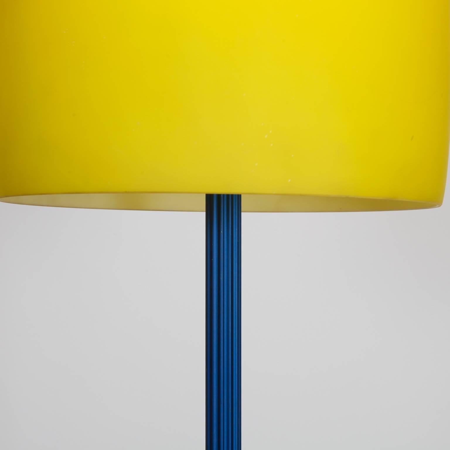 Italian floor lamp has a royal blue center support and vibrant yellow glass shade, circa 1980s. Attributed to the Memphis collection. New wiring for US electrical standards.
 