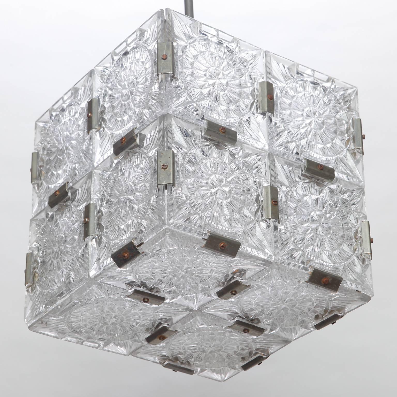 Cube shaped suspended cube light, circa 1970s made of clear molded glass panels and nickel metal joiners in the style of Kalmar of Austria. Dimensions shown are for glass fixture only, comes with adjustable rod and ceiling cap. New wiring for US
