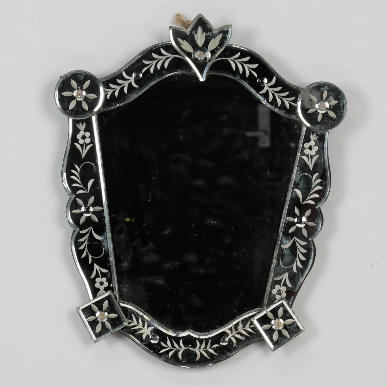 Venetian mirror in shield form with etched frame. Versatile size at just under 20” tall, circa 1940s.
 
