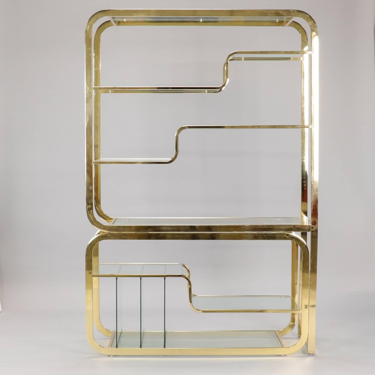 Brass and glass shelf unit by Milo Baughman for Design Institute of America. Can be configured as shown in photos or base can slide out to make it approximately 18” wider. Very good overall vintage condition with some scattered surface scratches to