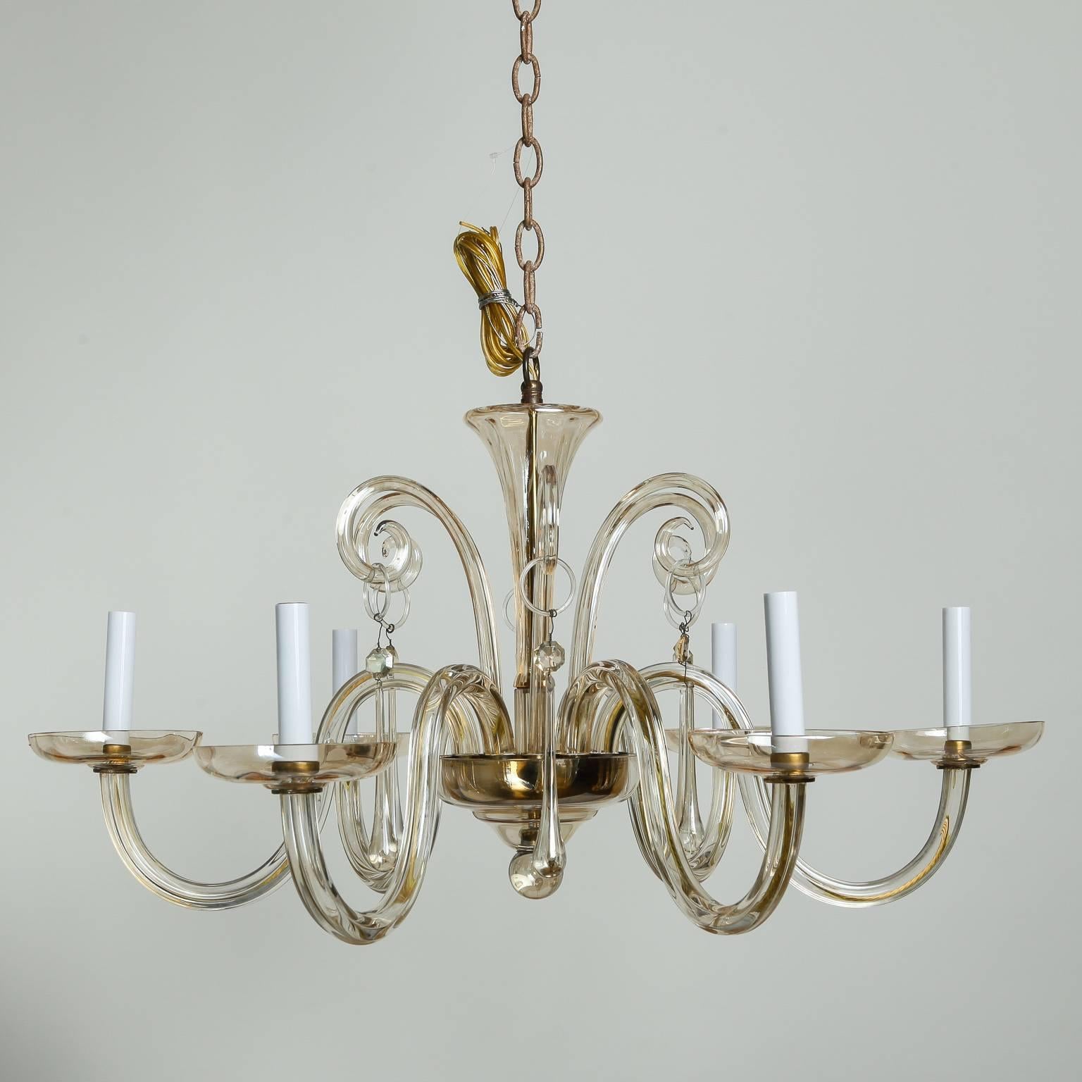 Six-light chandelier in pale amber Murano glass, circa 1960s. Sleek, clean lines with glass center shaft and bobeches and candle style lights. New wiring for US electrical standards.
