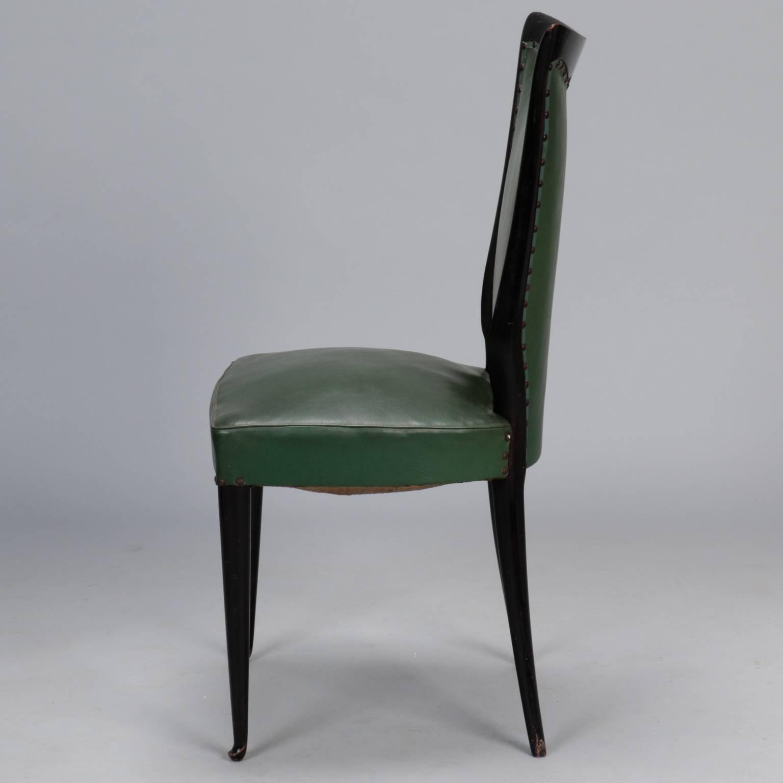 Mid-Century set of six Italian dining chairs date from late 1950s and are attributed to Osvaldo Borsani. Chairs have wood frames with espresso colored stained finish, tapered legs, curvy seat backs with flared tops and original green faux leather