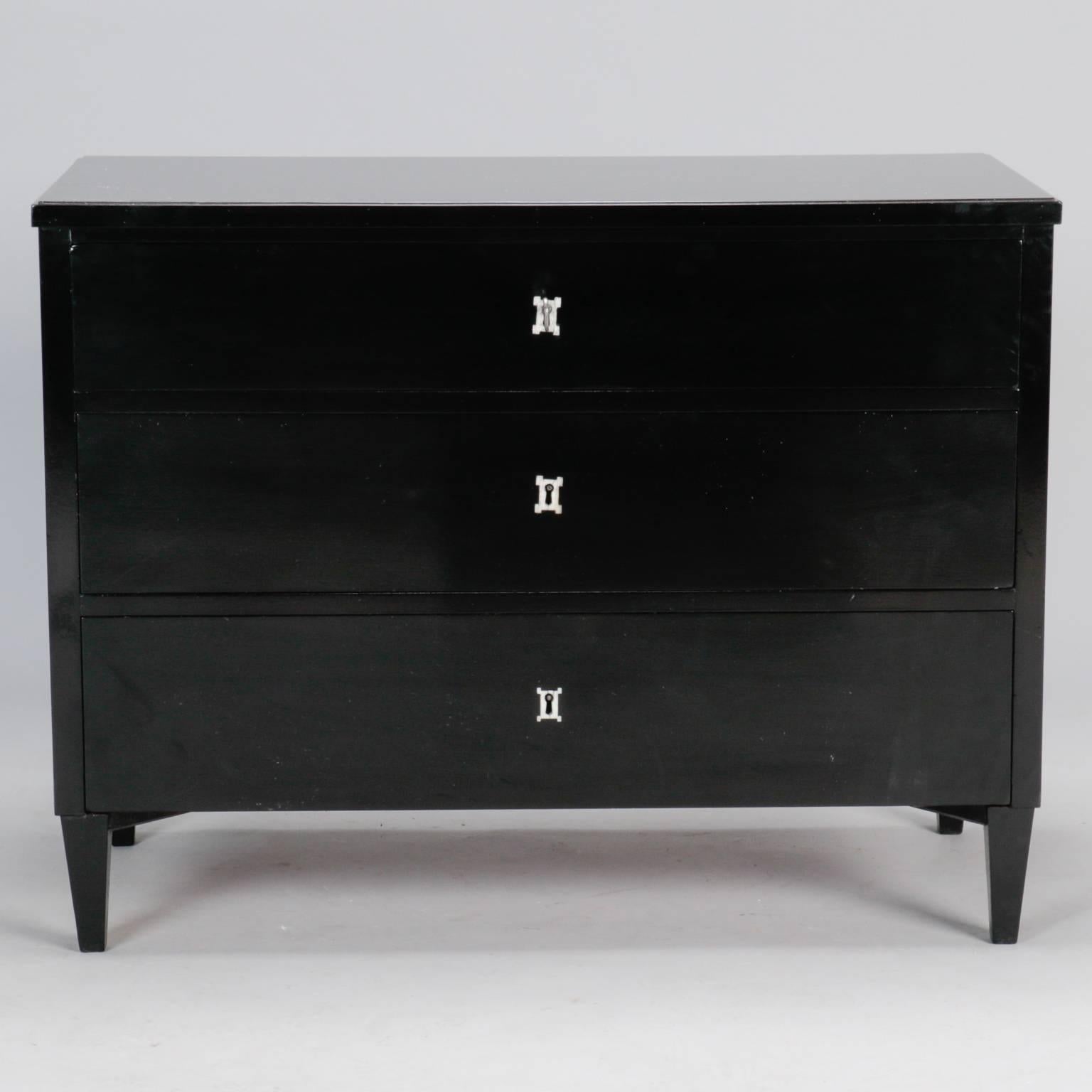 Found in England, this circa 1940s three-drawer chest has a new ebonised finish, silver tone hardware and is solidly constructed with dove tailed drawers. This versatile piece can be placed in a hall or entryway, beside a sofa, chair, bed.
  
